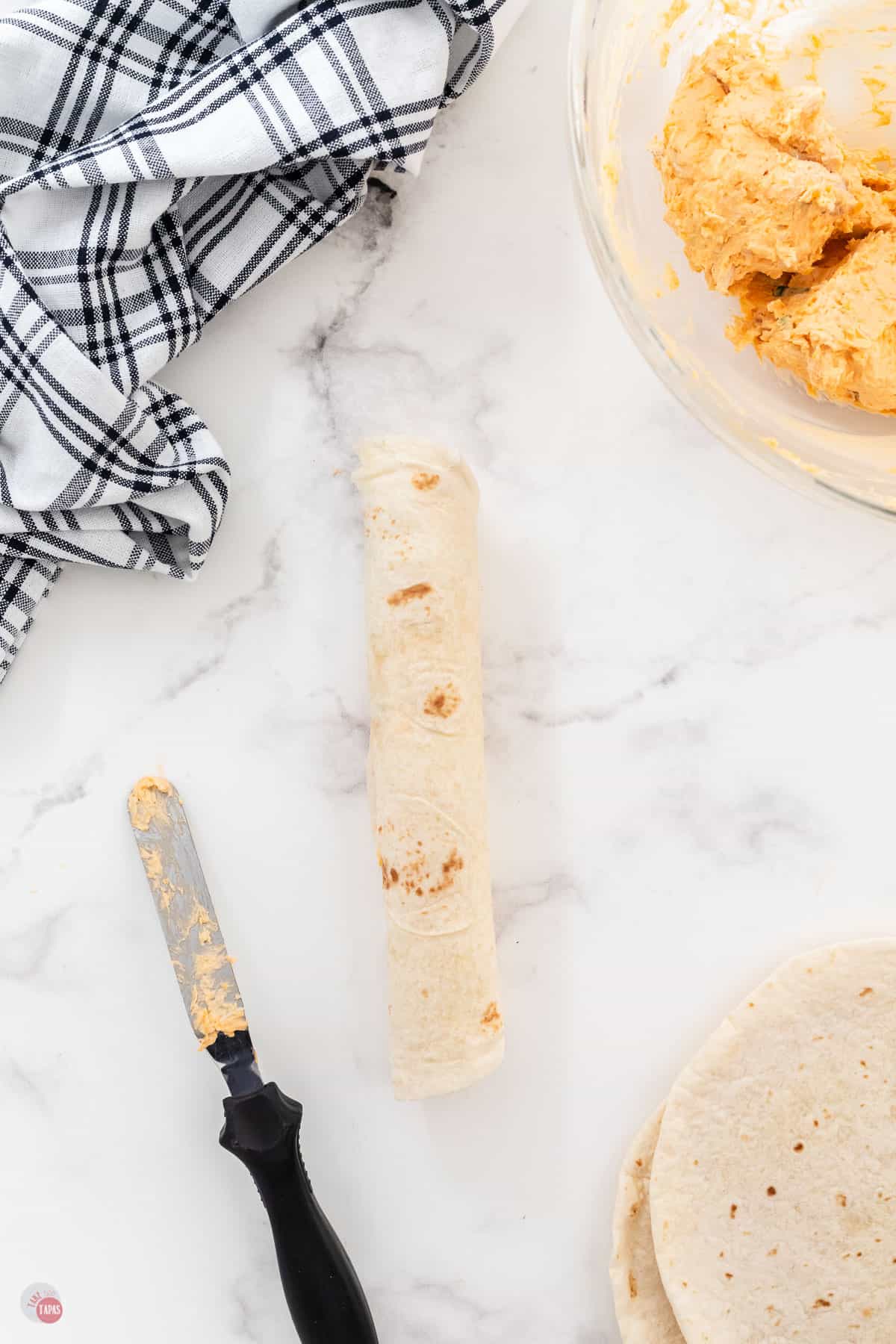 rolled up tortilla on marble