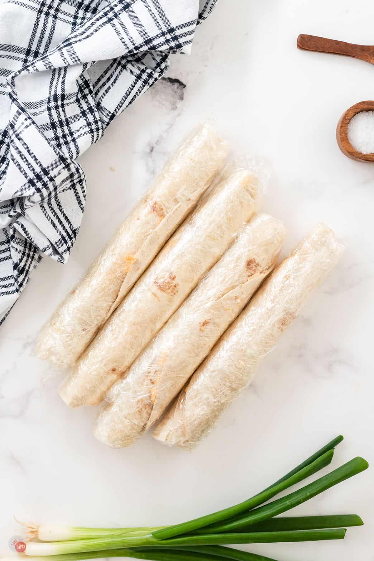 tortillas wrapped in plastic on marble