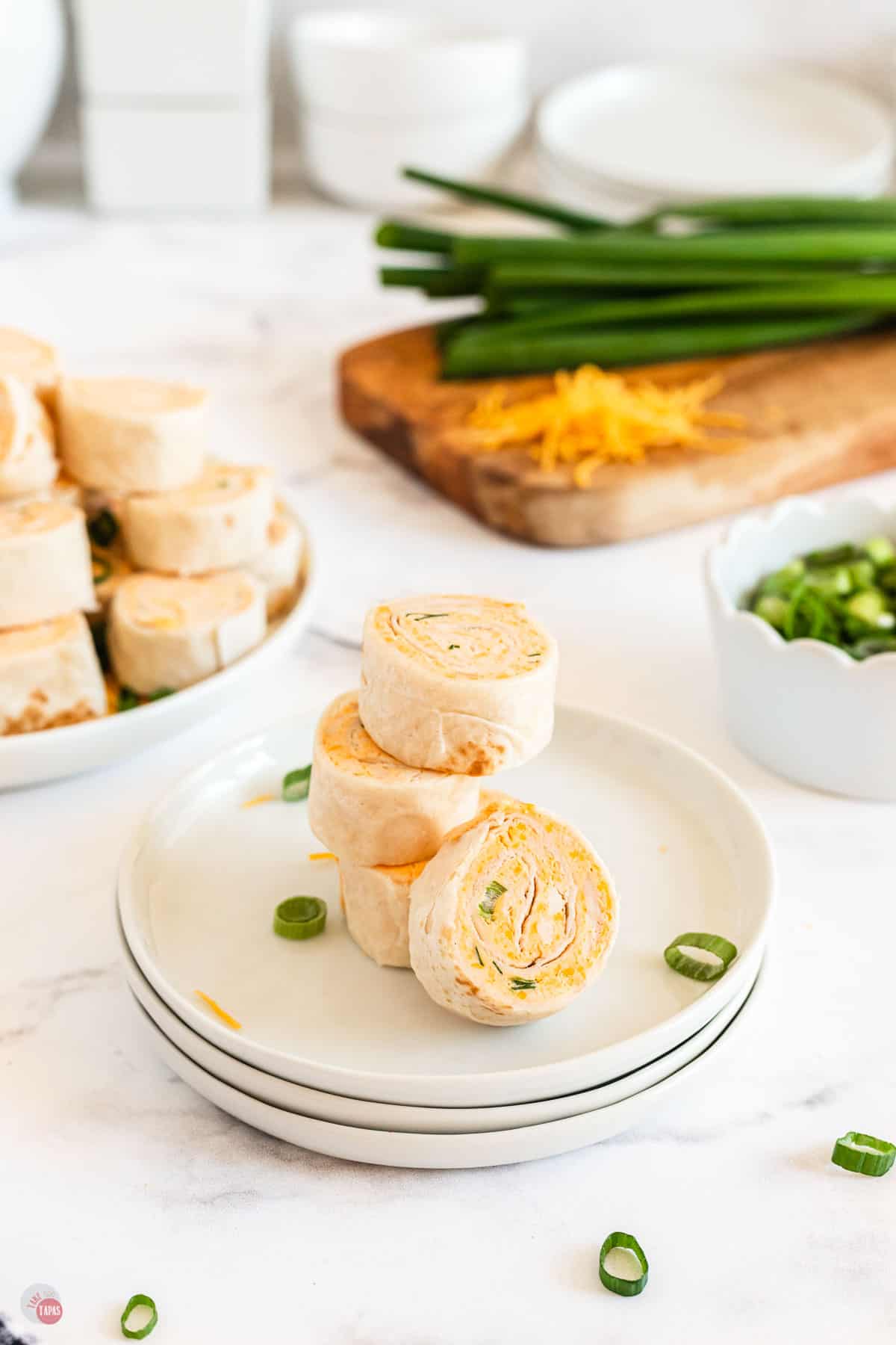 stack of buffalo chicken pinwheel sandwiches on a white plate