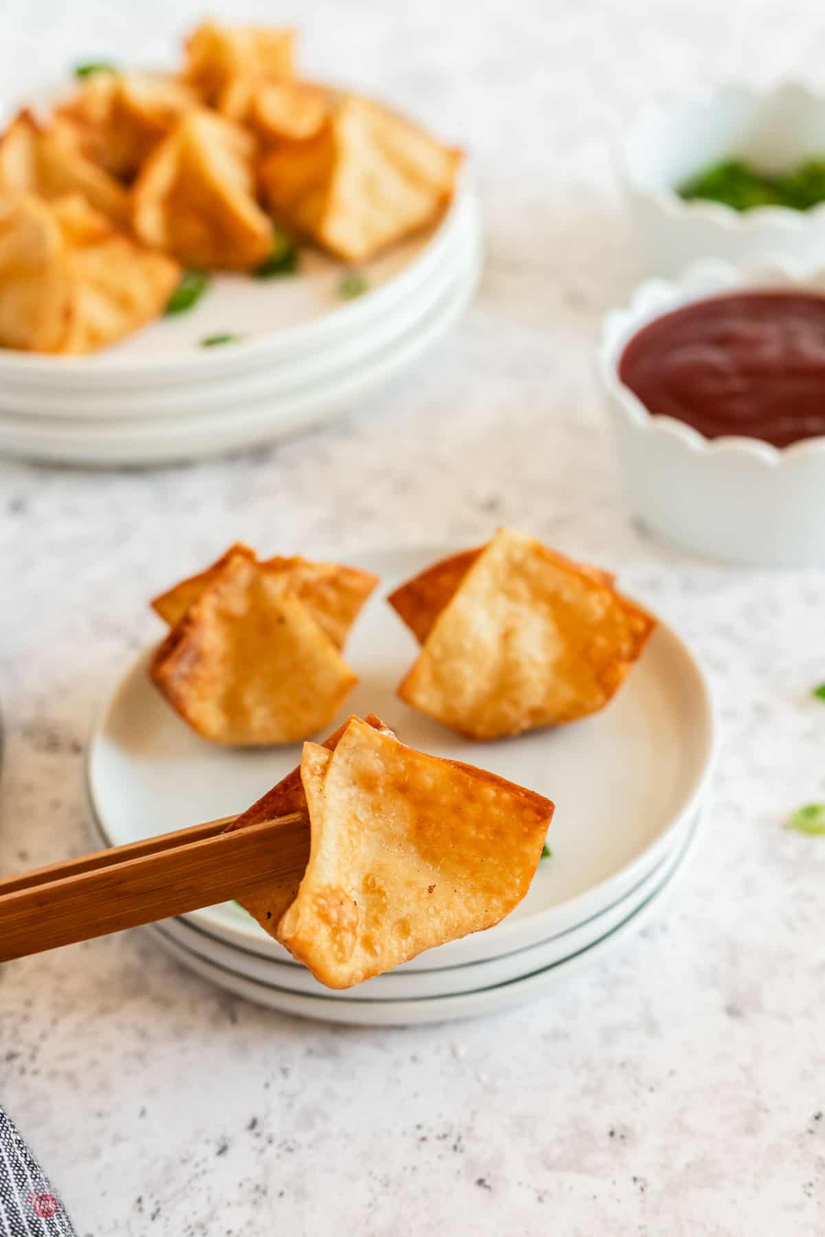 chopsticks holding wonton