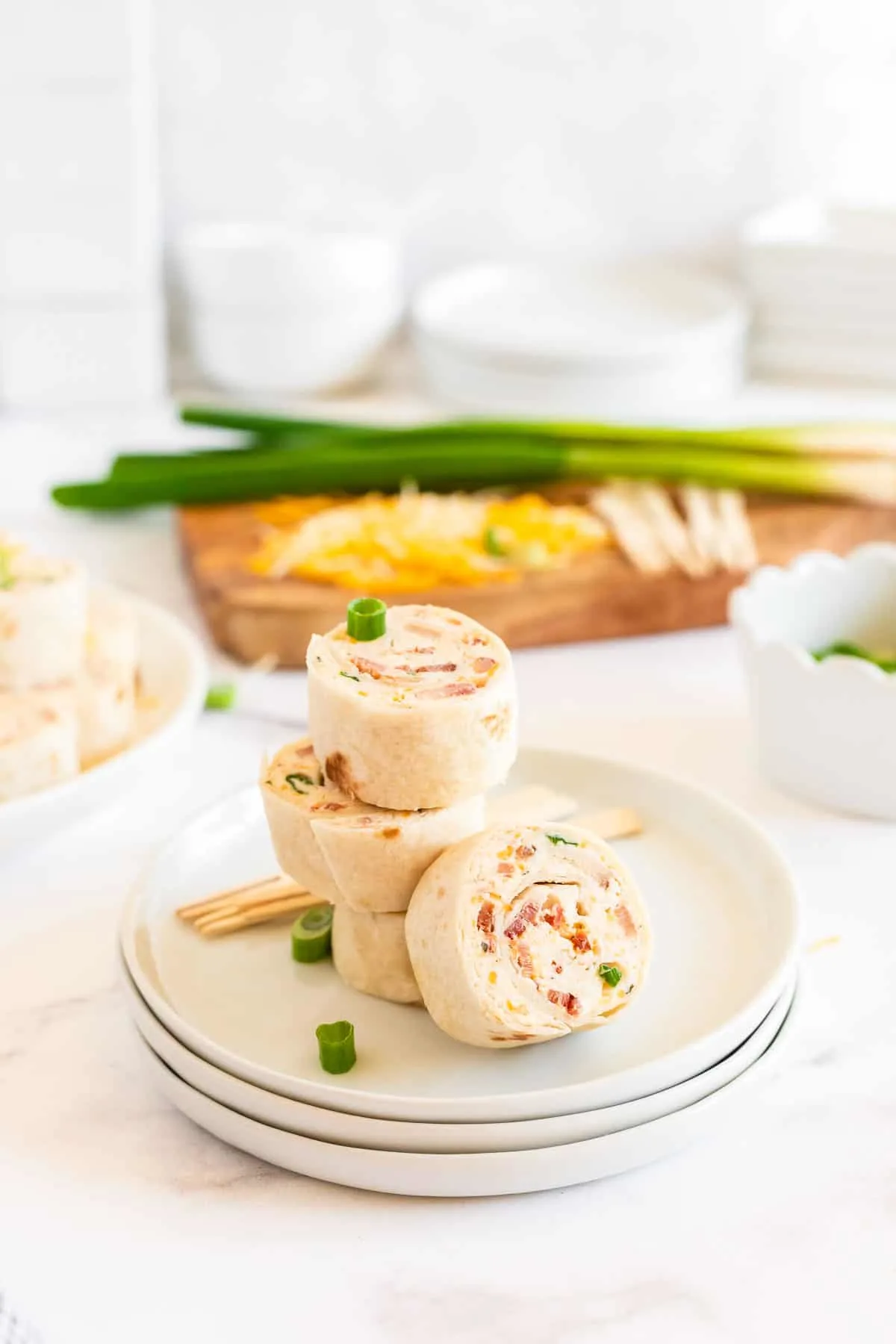 plate with stack of crack chicken pinwheels sandwiches