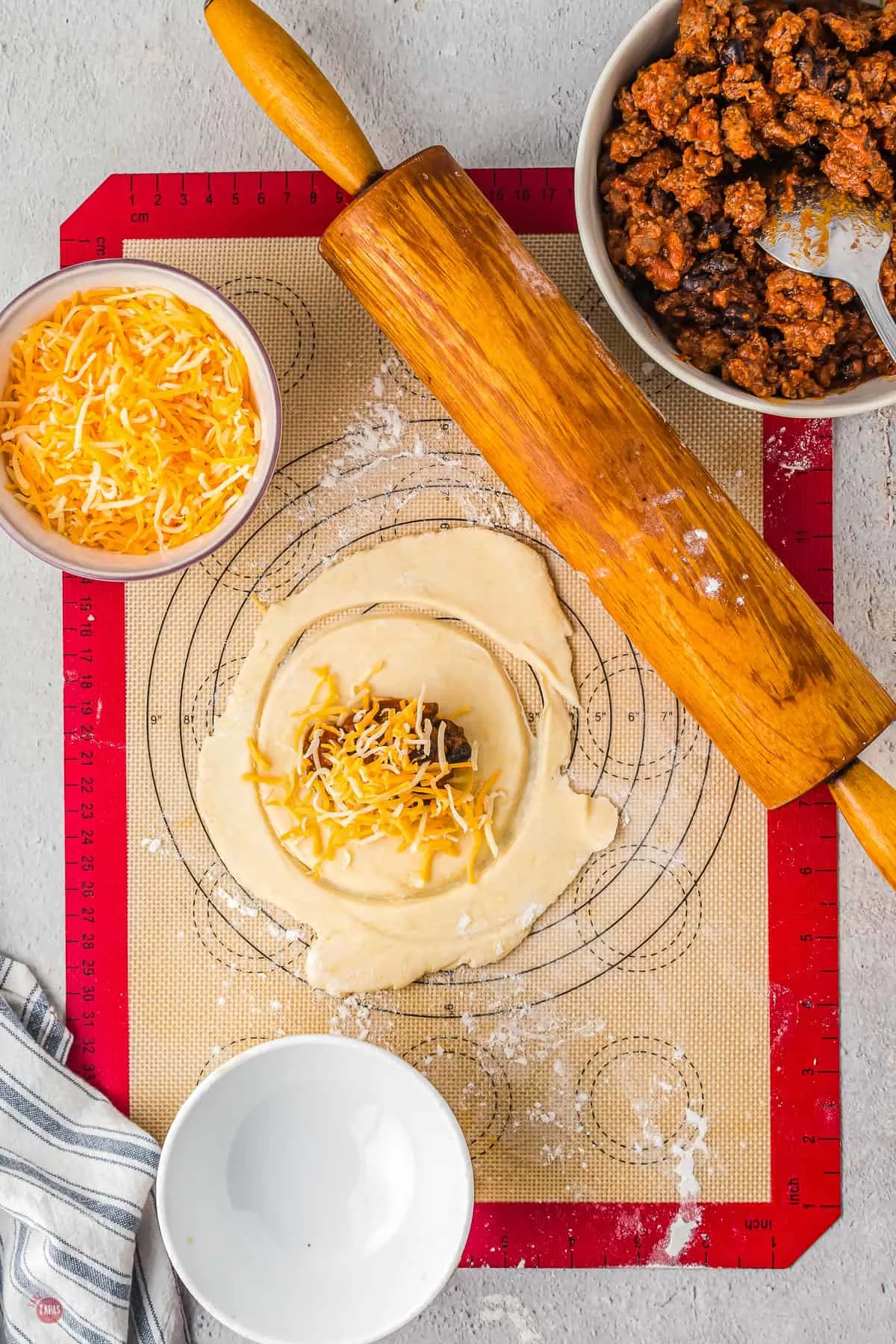 dough on a pastry board with cheese