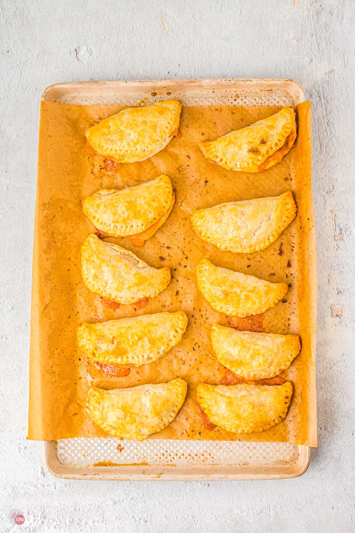 baked empanadas on a baking sheet