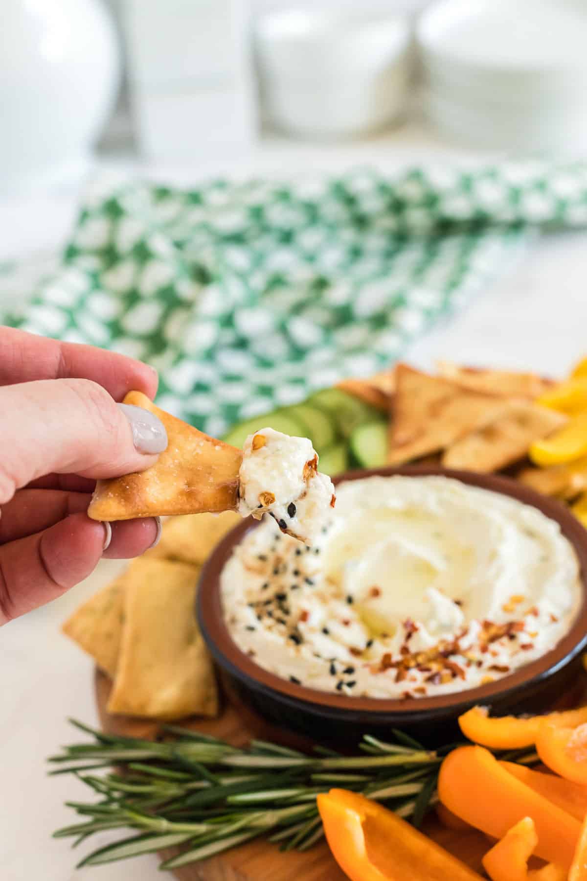 bowl of whipped feta dip and a pita chip