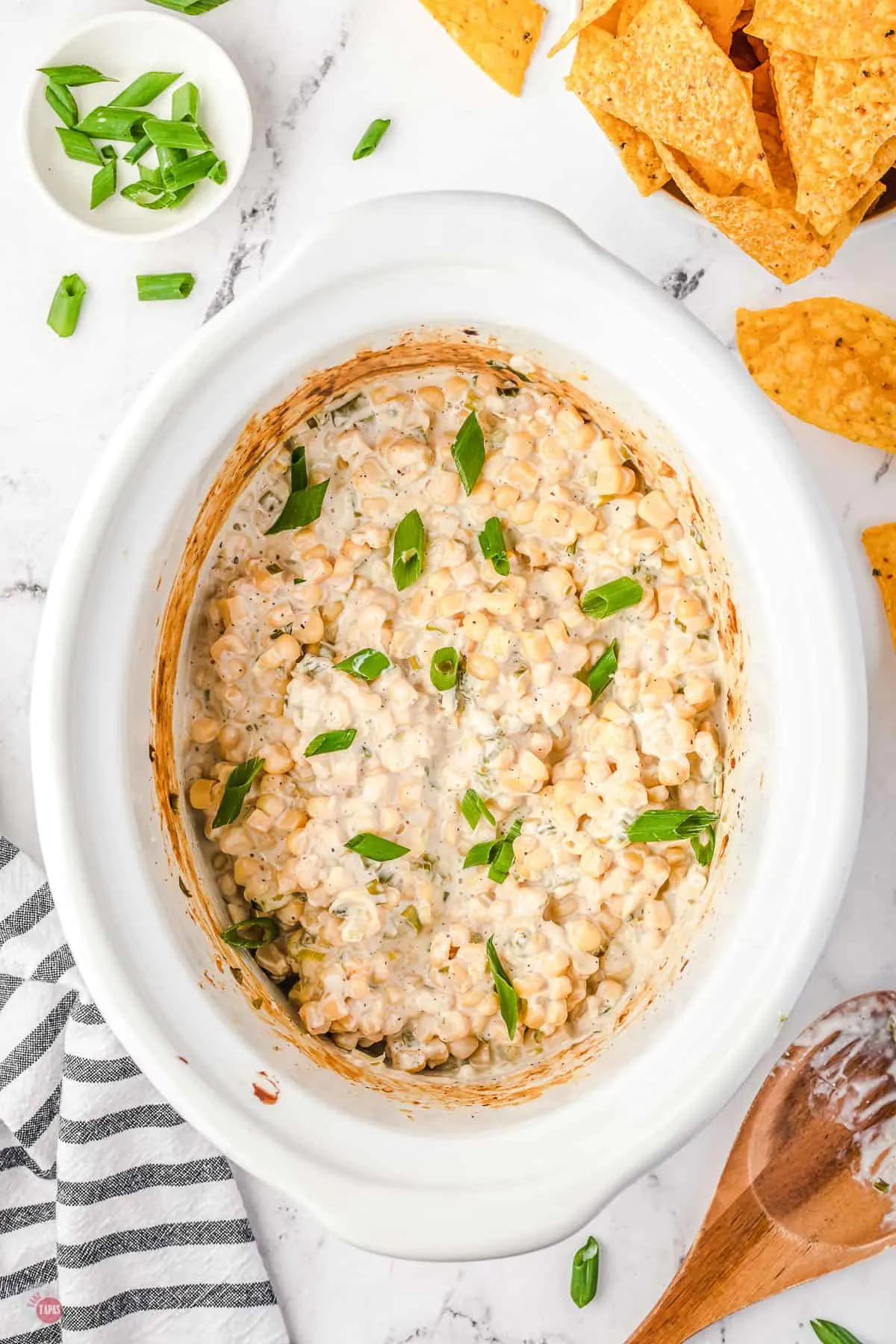 corn dip in a white crock pot bowl