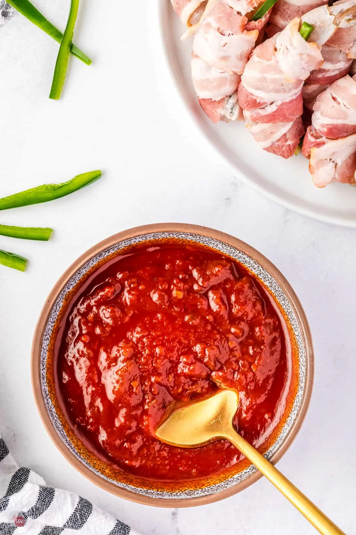 cocktail sauce in a bowl with a gold spoon