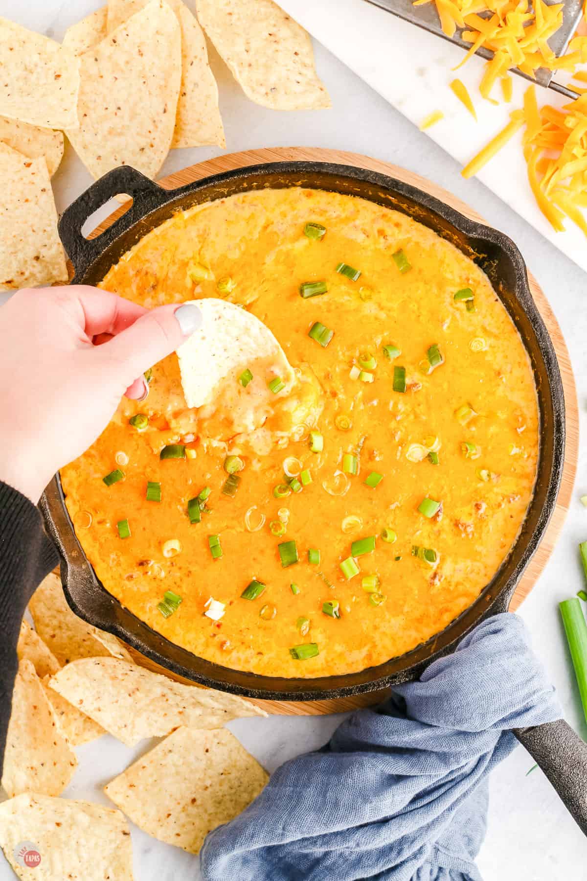 dipping tortilla chip in hamburger dip