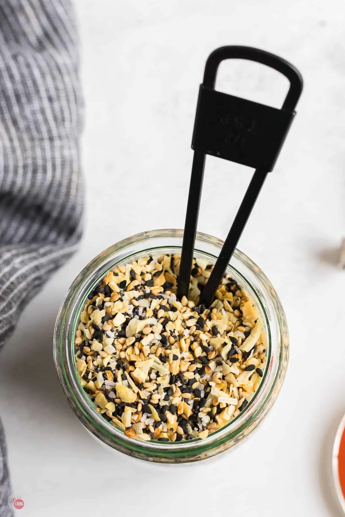 jar of seasoning with black spoon