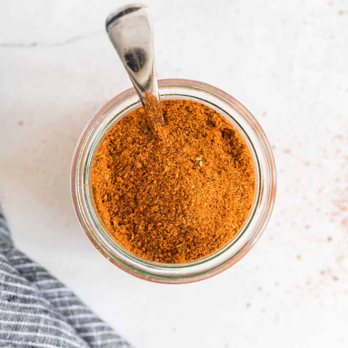 jar of old bay seasoning with spoon