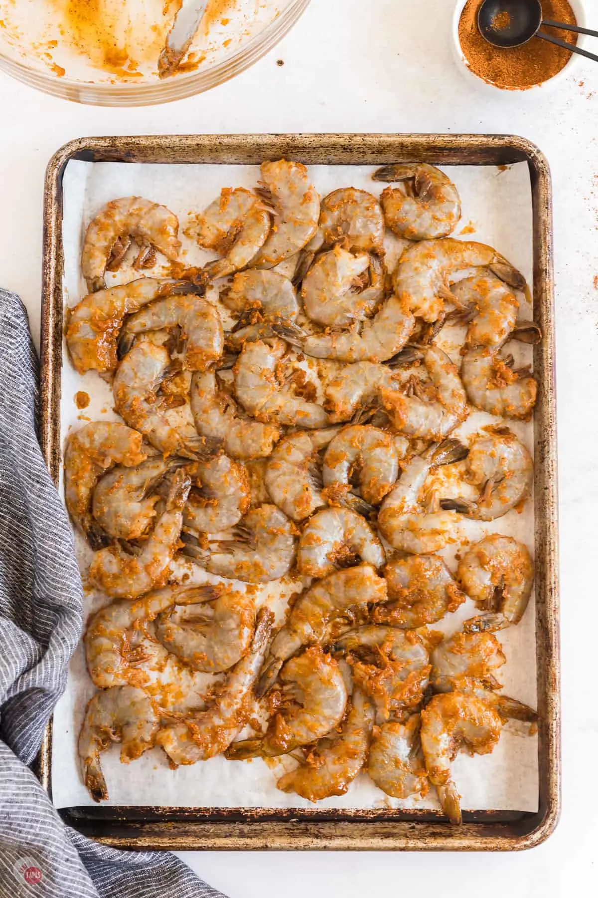 uncooked shrimp on a baking sheet