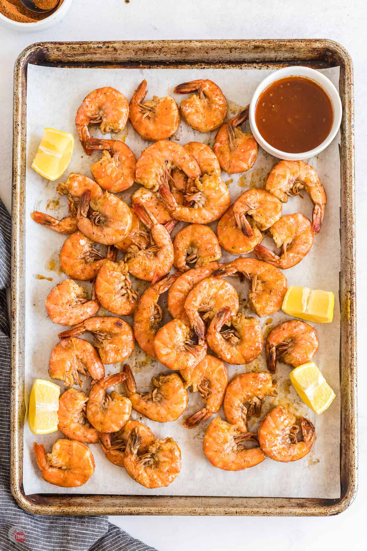 shrimp and lemons on a baking sheet