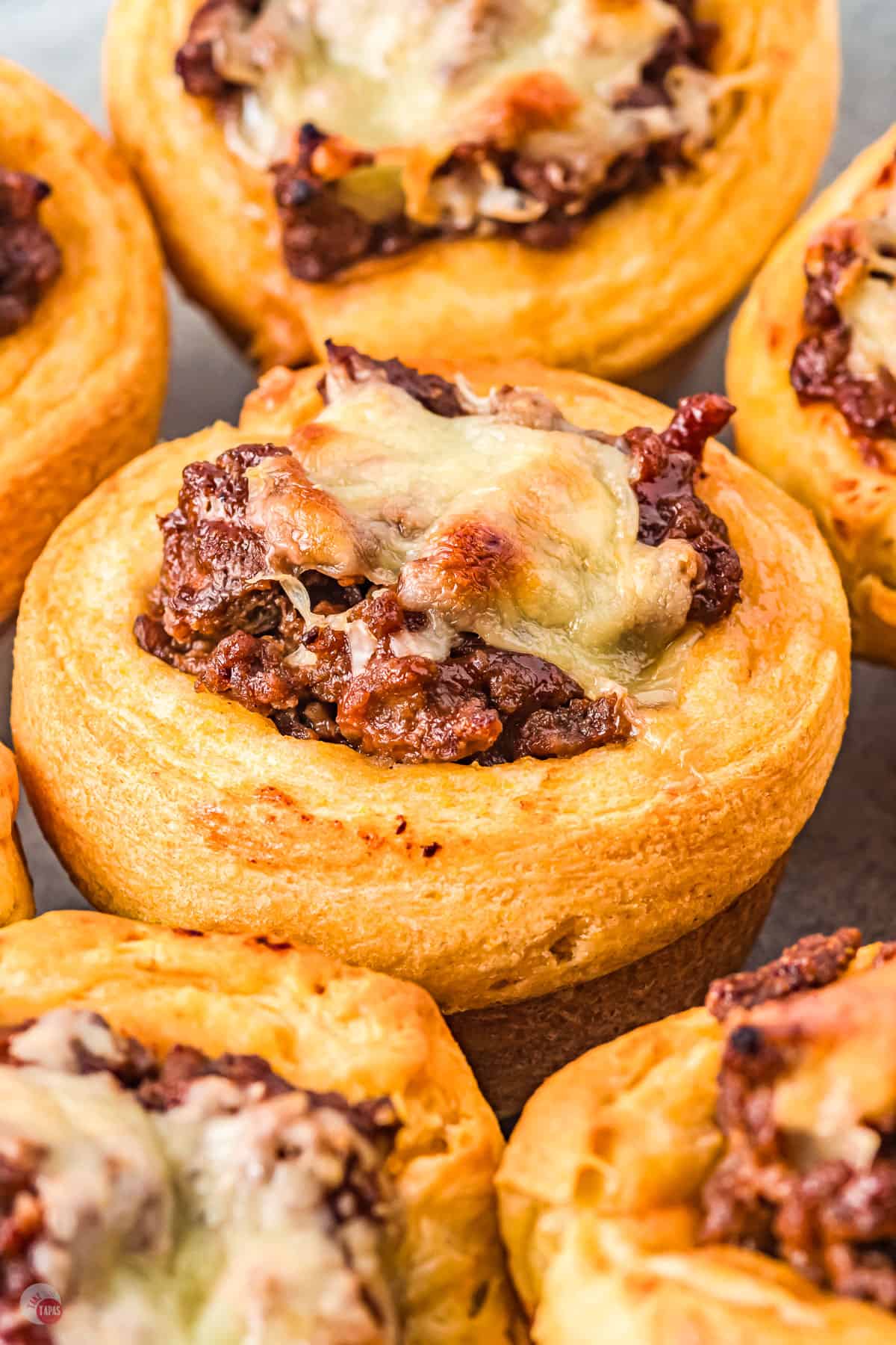 Close up of sloppy joe cups with melted cheese on top. 