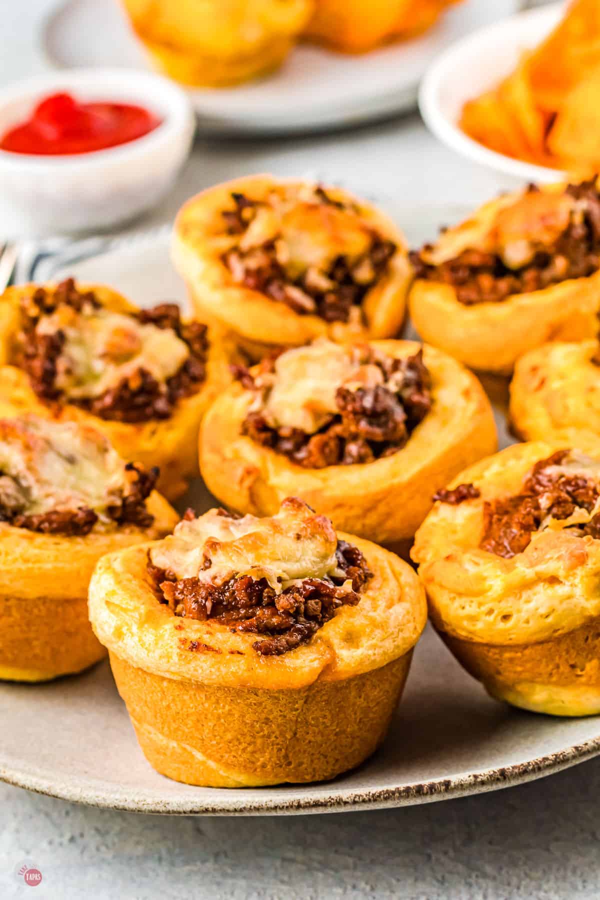 close up of biscuit cups with ground beef on them