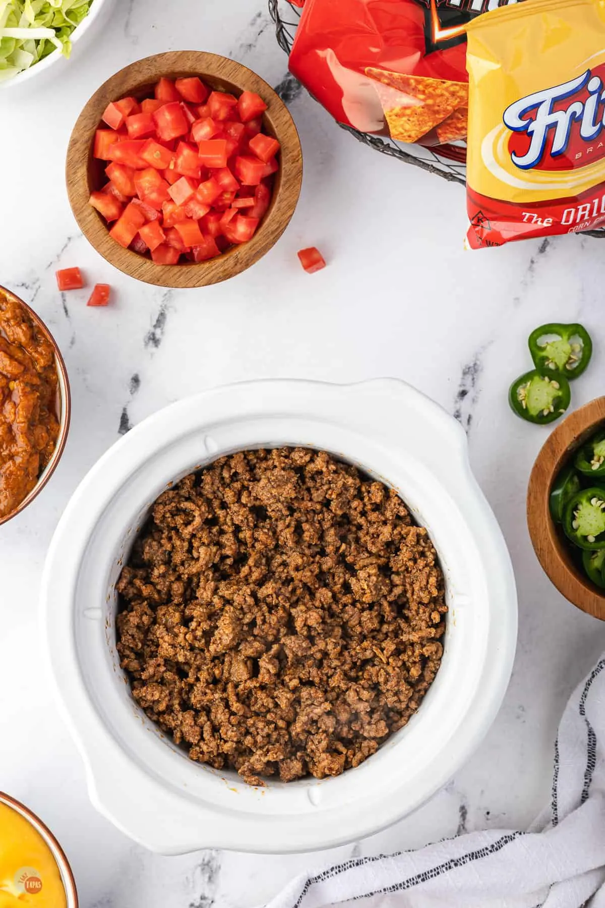 cooked taco meat in a white crock pot
