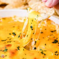 dip stretching from tortilla chip to bowl