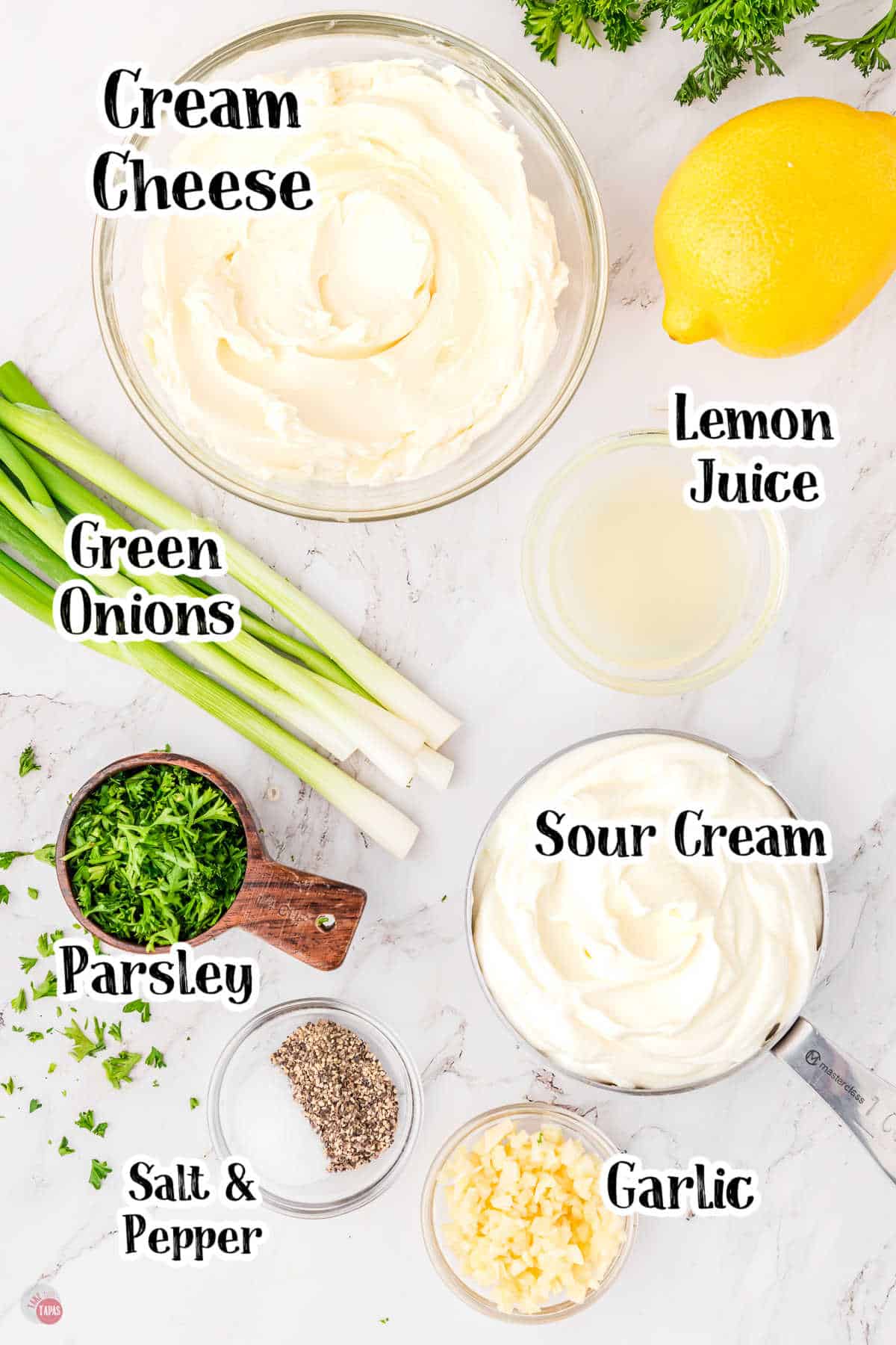 Worktop with small balls filled with ingredients including: Cream Cheese
Sour Cream
Green Onions
Parsley
Lemon Juice
Garlic
Salt and Pepper