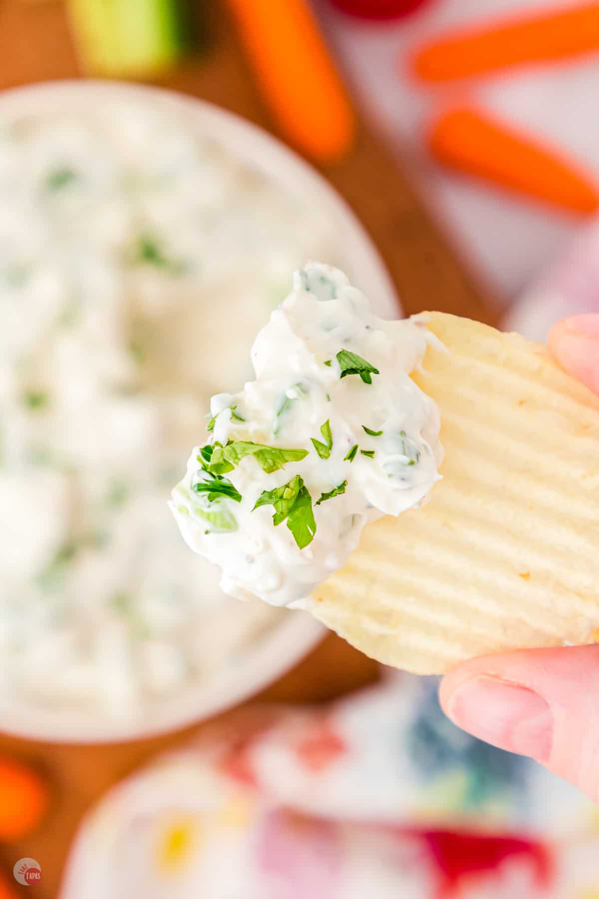 close up of crinkle potato chip with dip on it