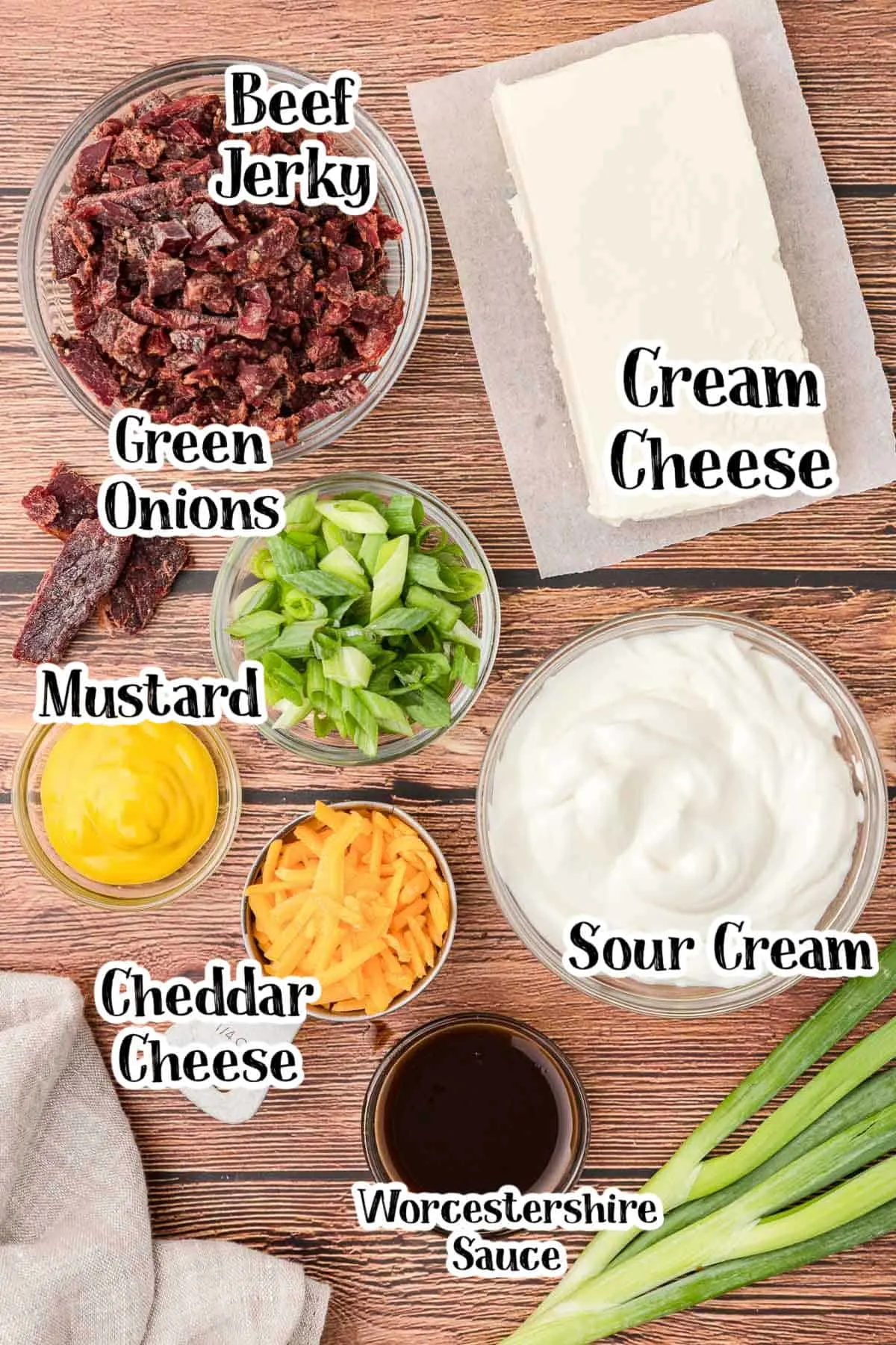 labeled picture of dip ingredients on a wood board