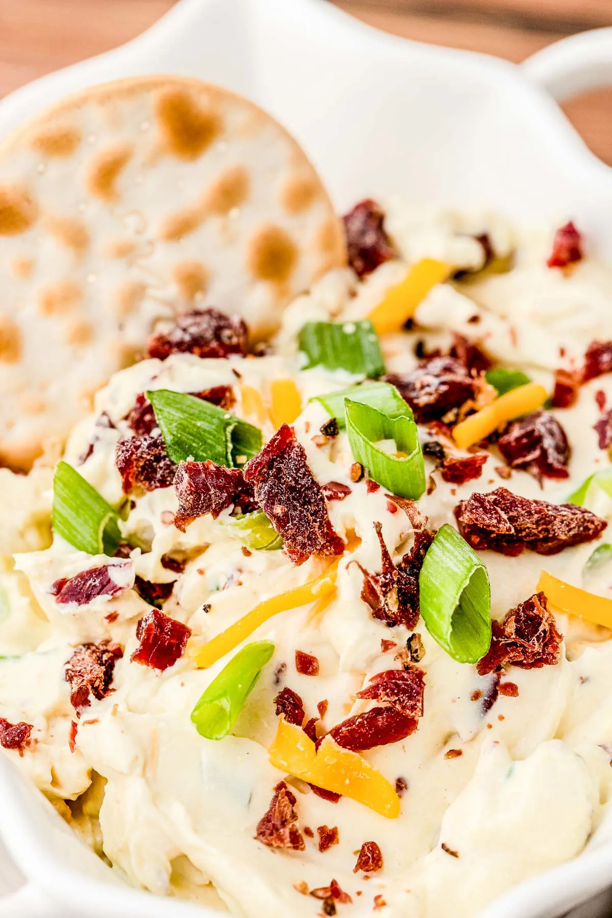 bowl of dip topped with beef jerky