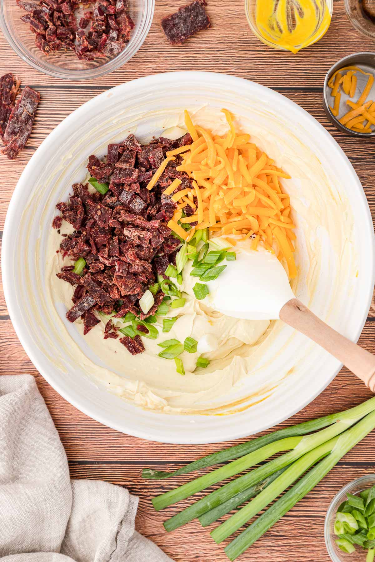 beef jerky and cheese in a bowl with a spatula