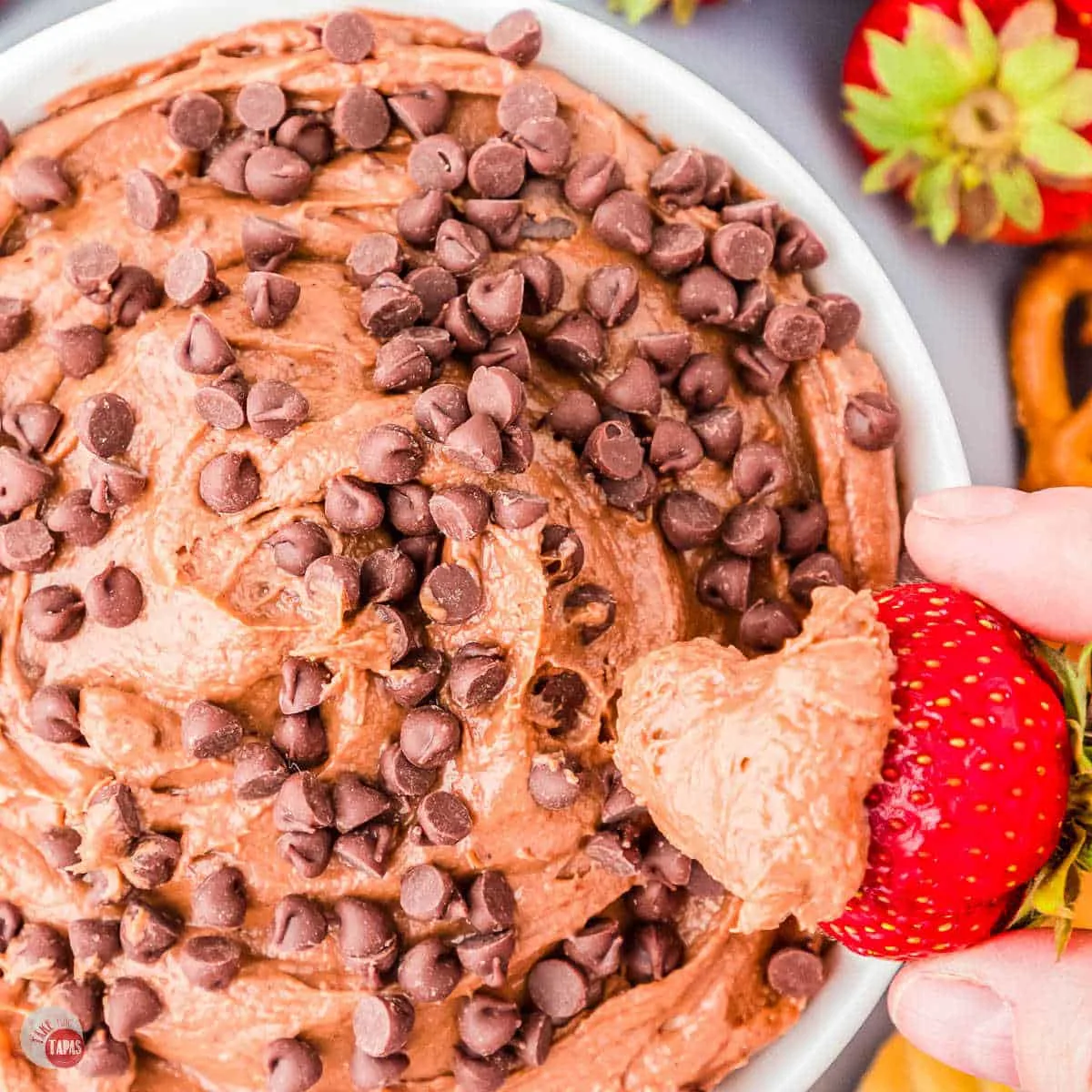 bowl of dip and chocolate chips with a strawberry