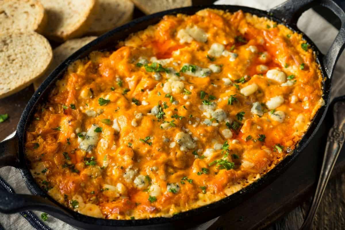 cast iron pan full of hot buffalo chicken dip