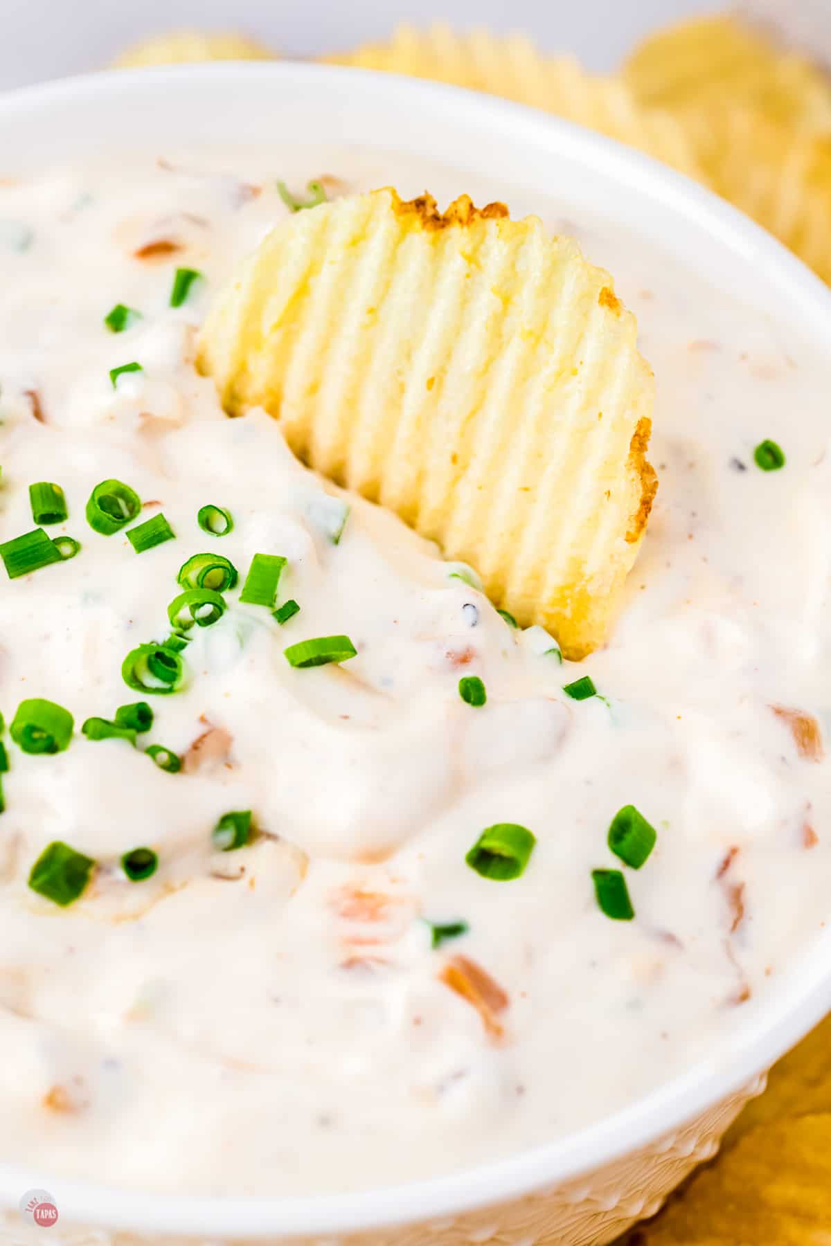 bowl of dip with a chip stuck in it