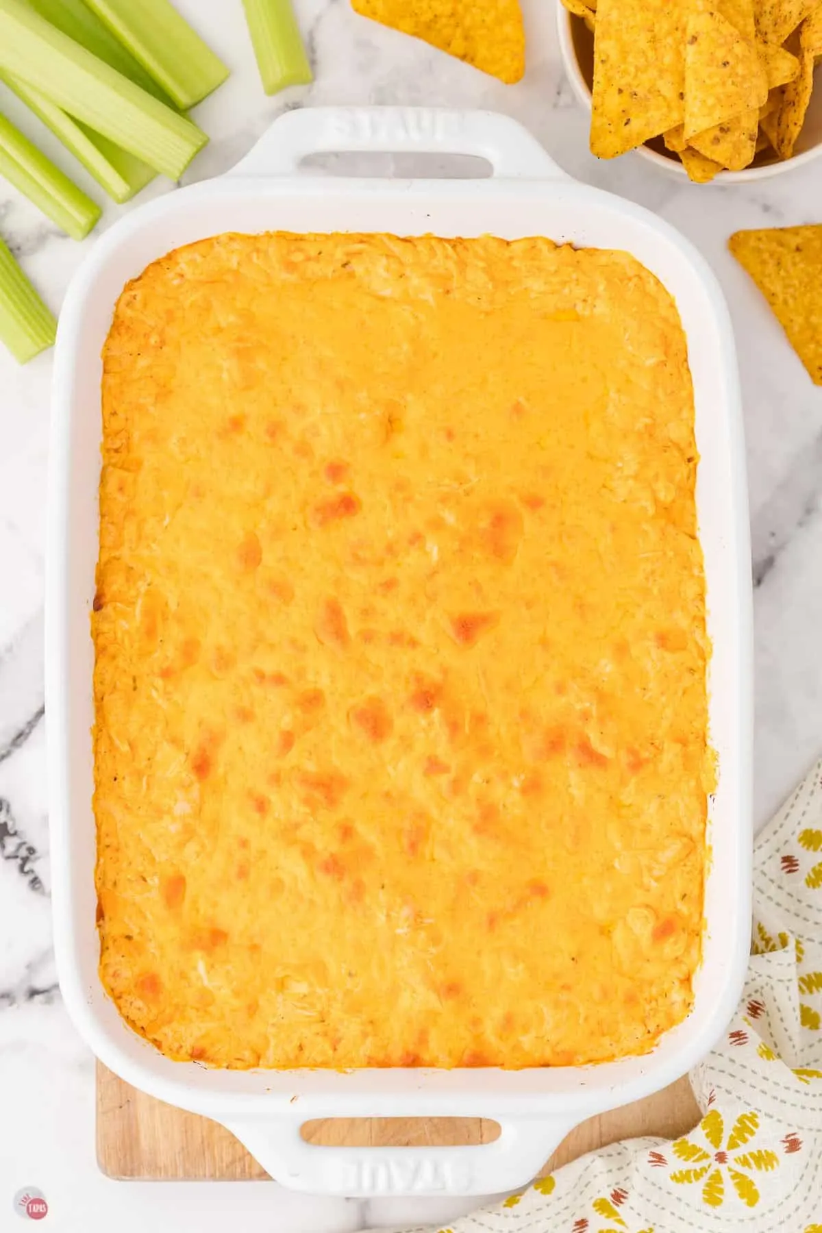 baked buffalo chicken dip in a white dish