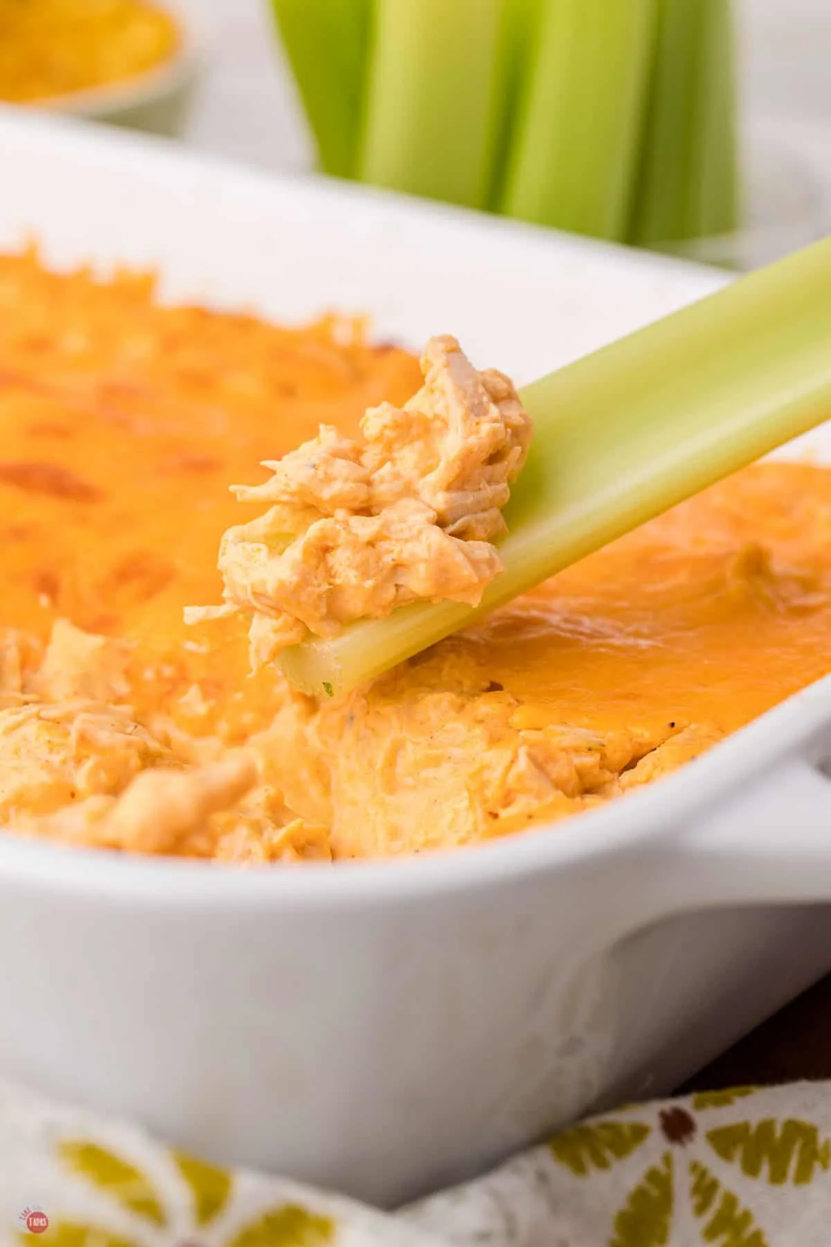 celery stick scooping out buffalo chicken dip