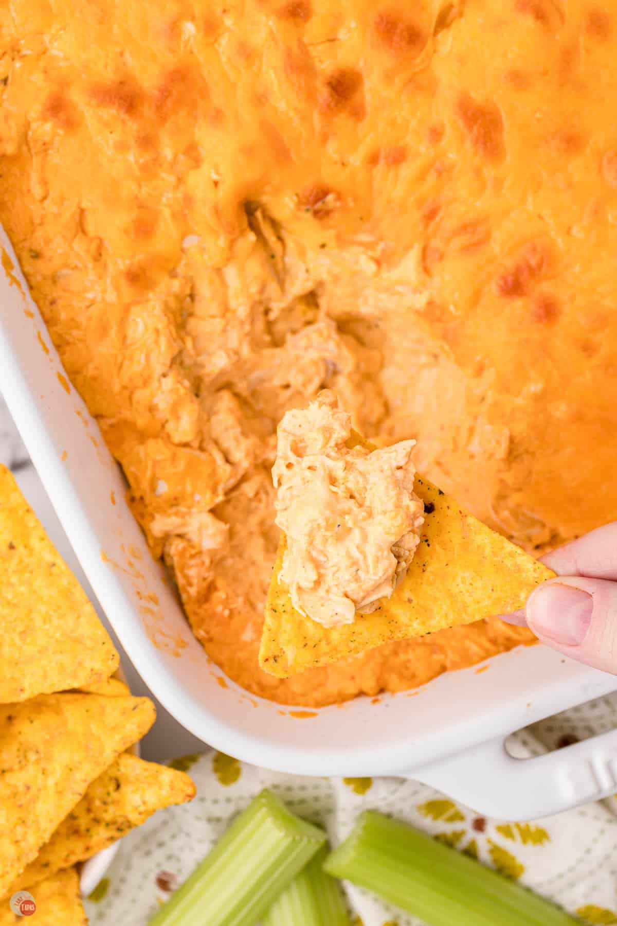 buffalo chicken dip with a chip taking some out