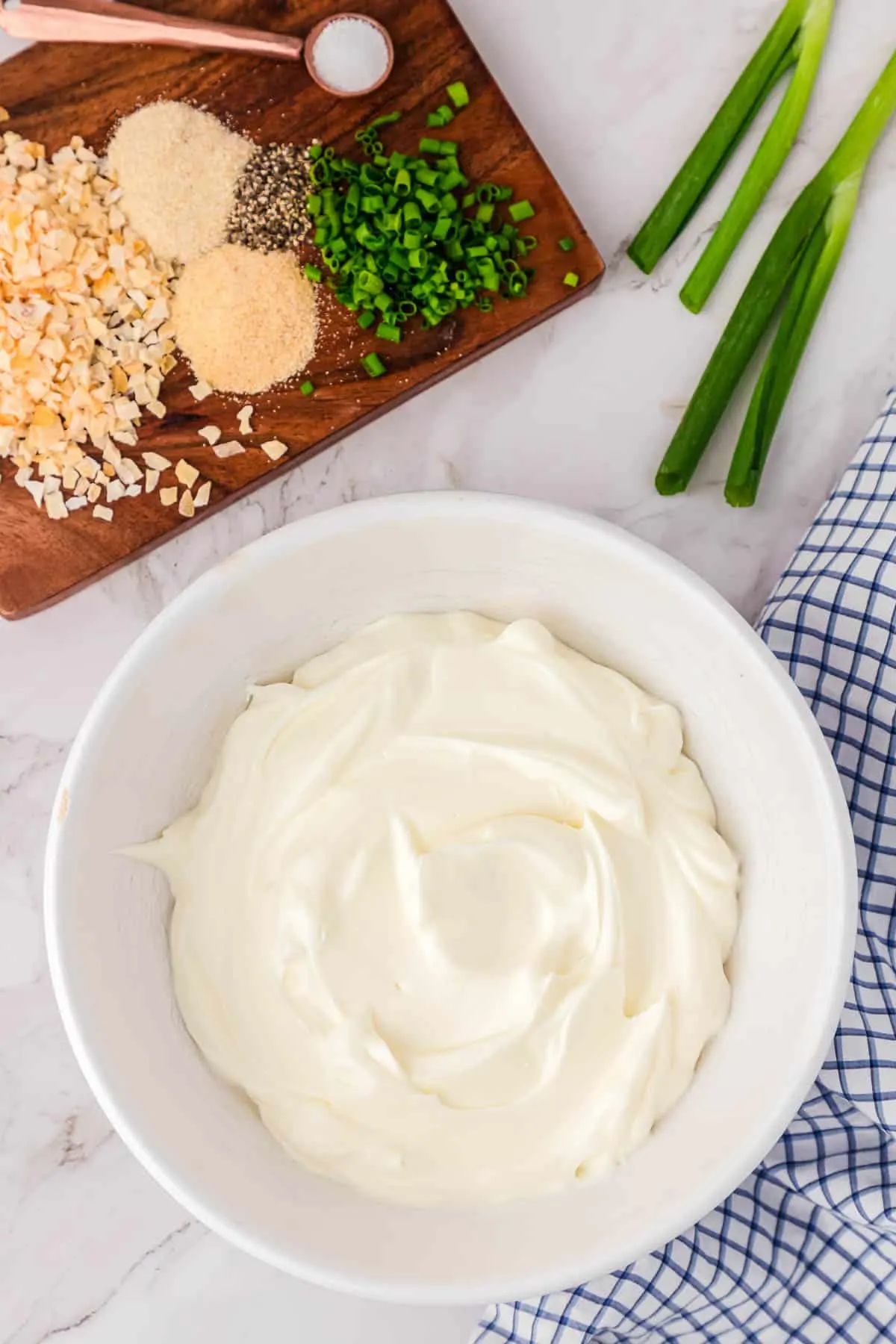 sour cream in a bowl with ingredients around it