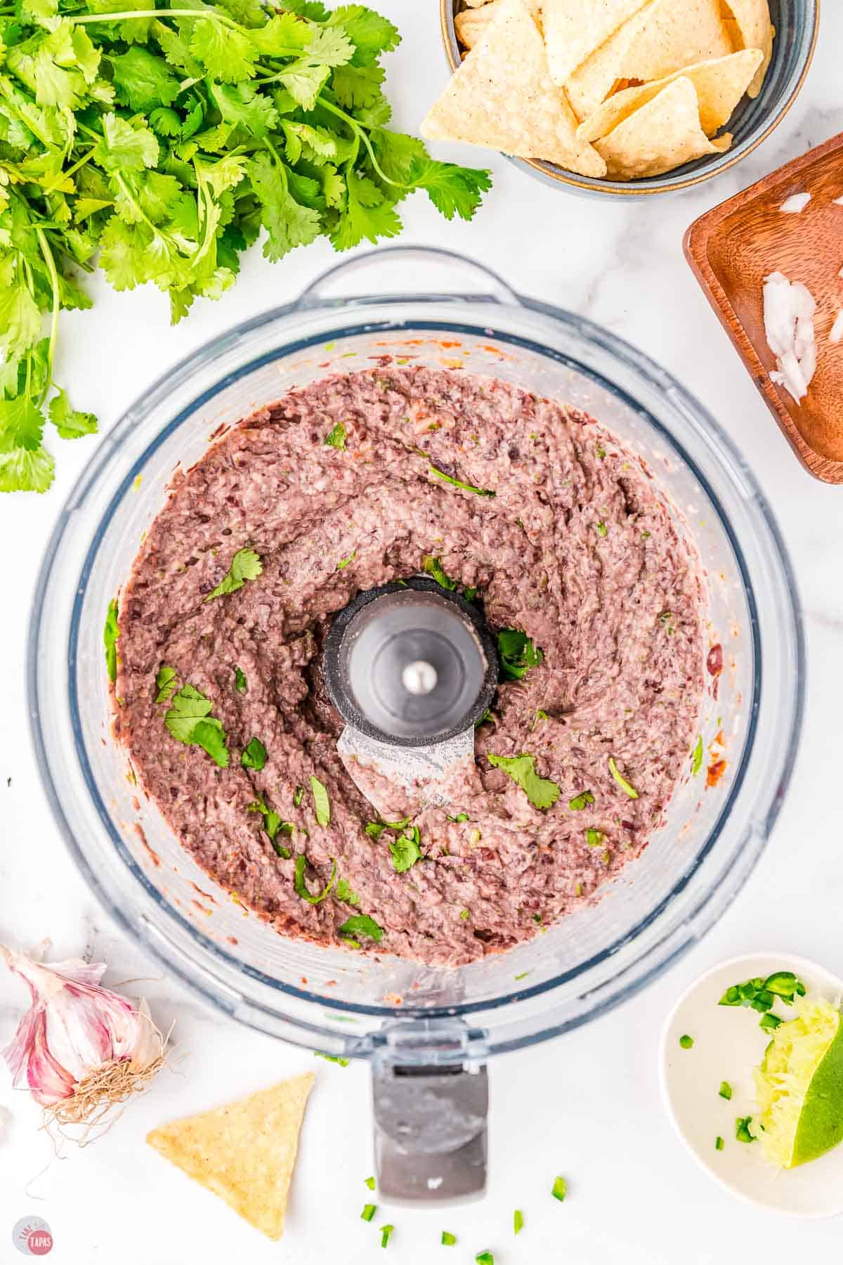 black beans being pulsed in a food processor