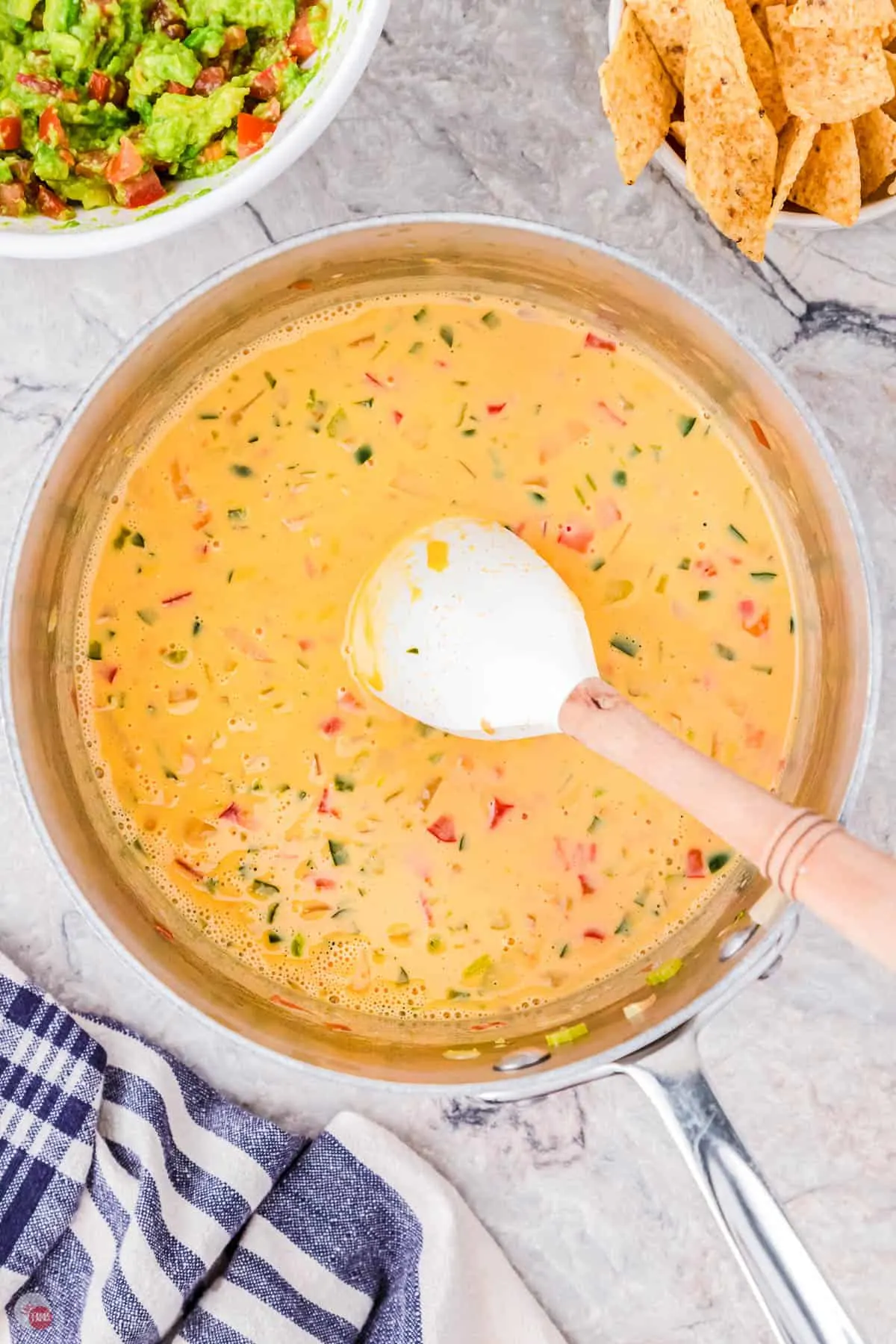 queso dip stirring in a pot