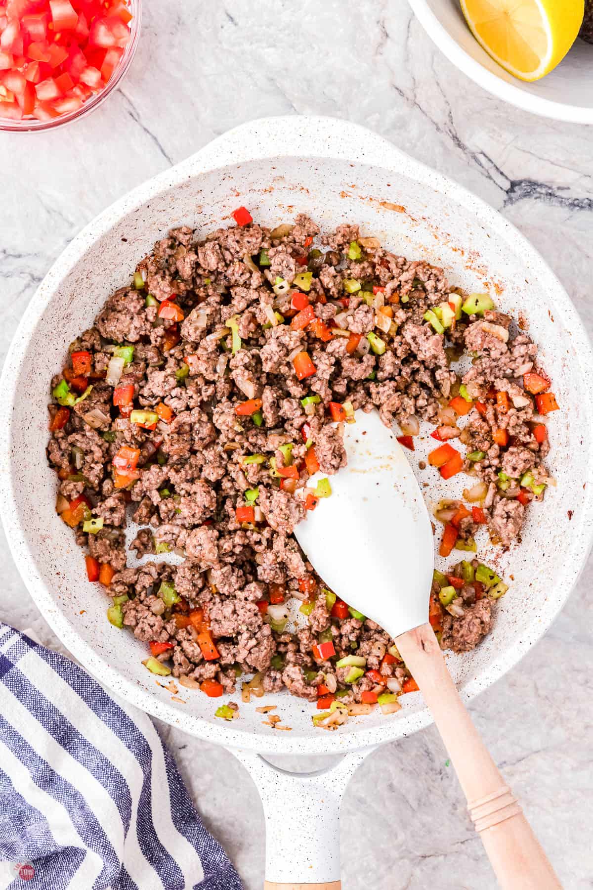 cooked ground beef and veggies in a white skillet
