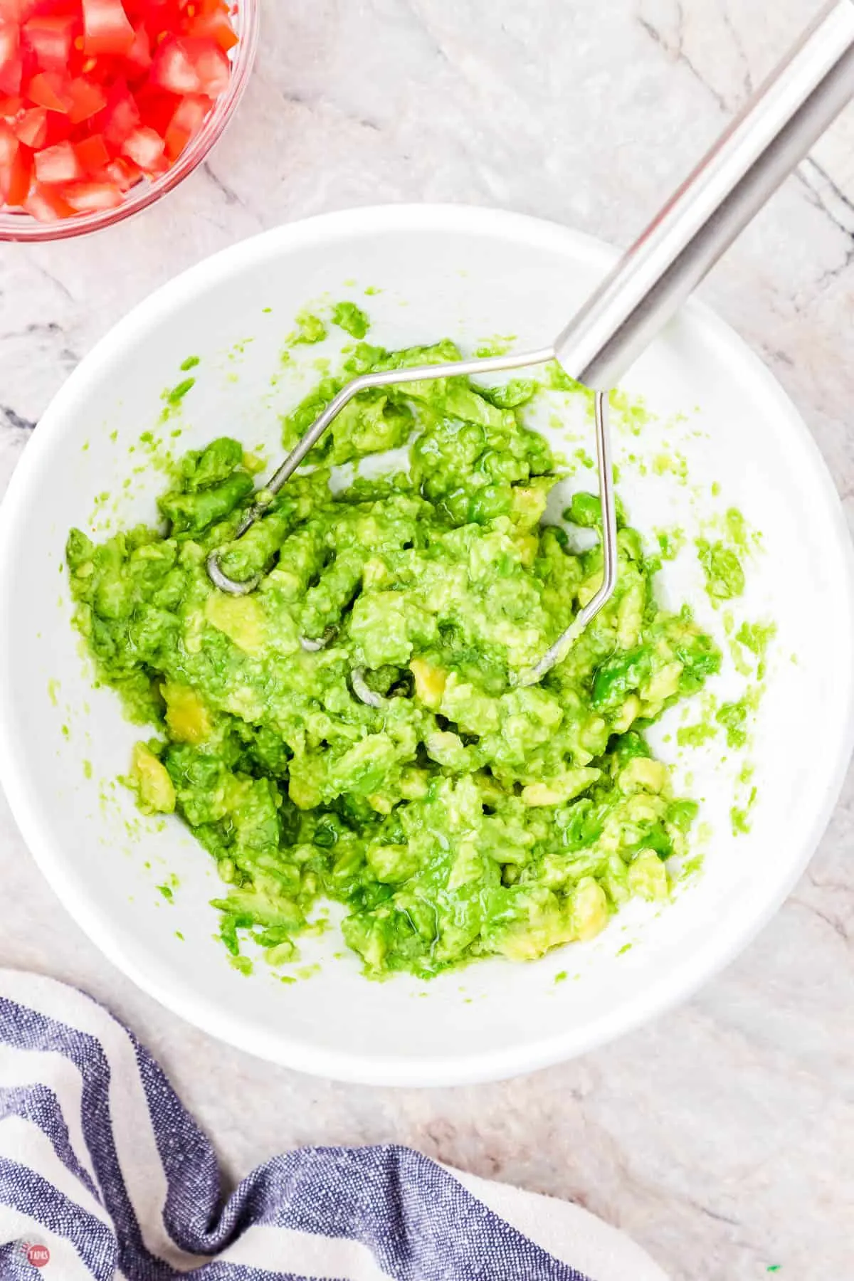mashed avocado in a white bowl
