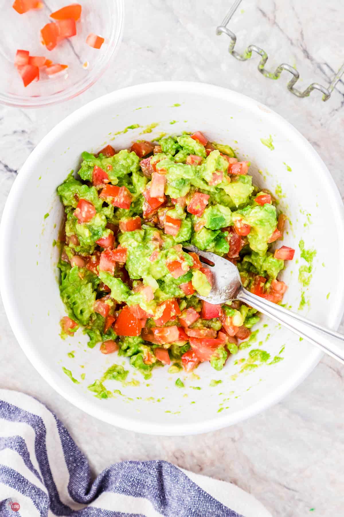 guacamole in a bowl with a spoon