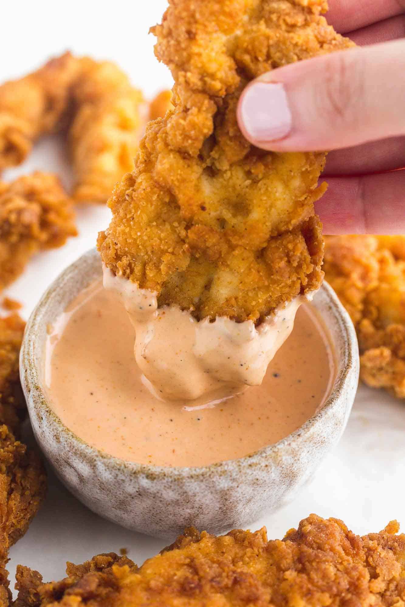 Raising Cane's sauce with a chicken nugget