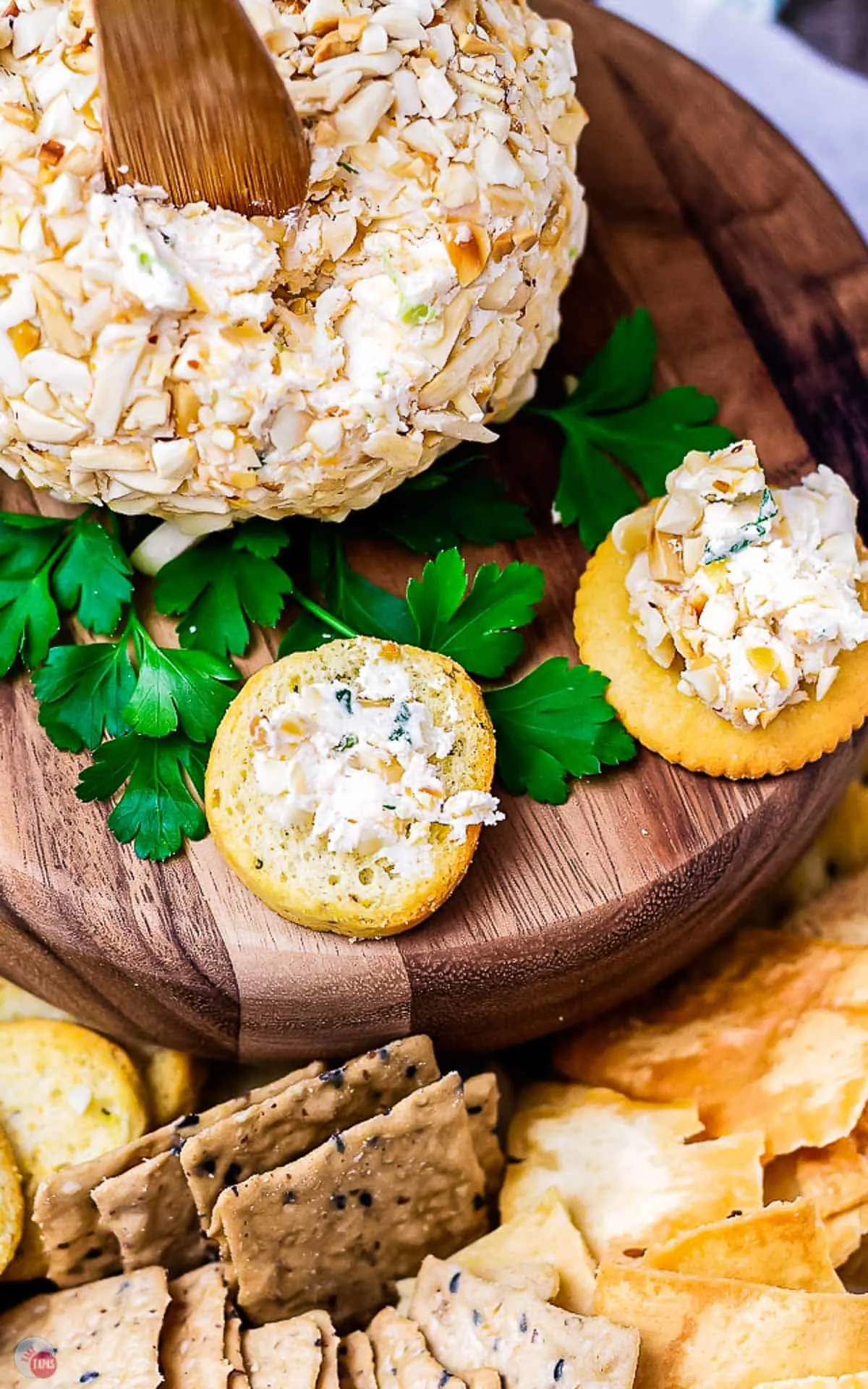 two crackers on a wood platter with parsley