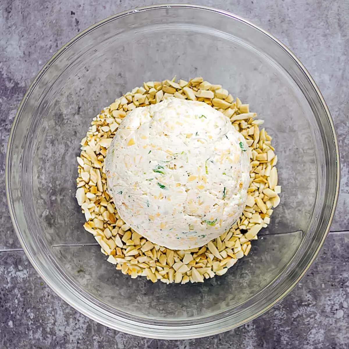 cheese ball in bowl of nuts