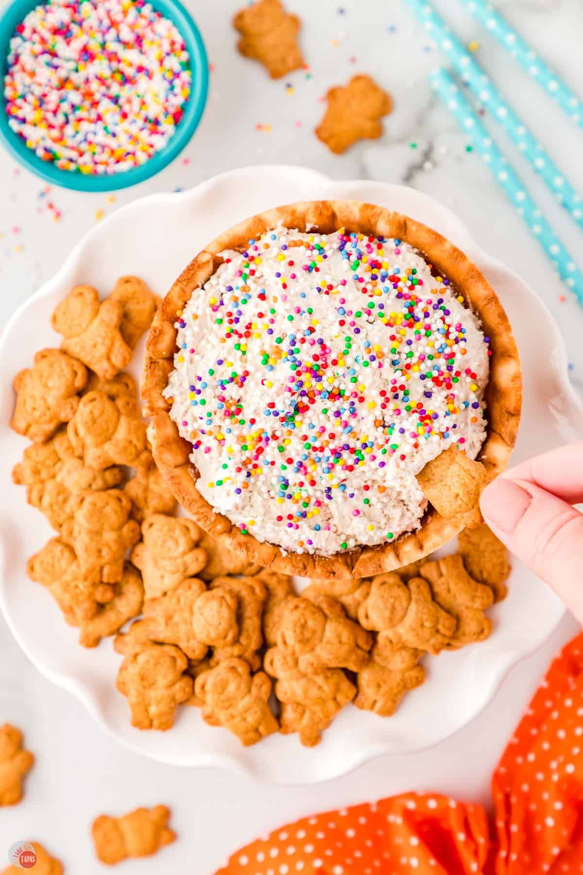 waffle bowl full of funfetti dip with teddy grahams