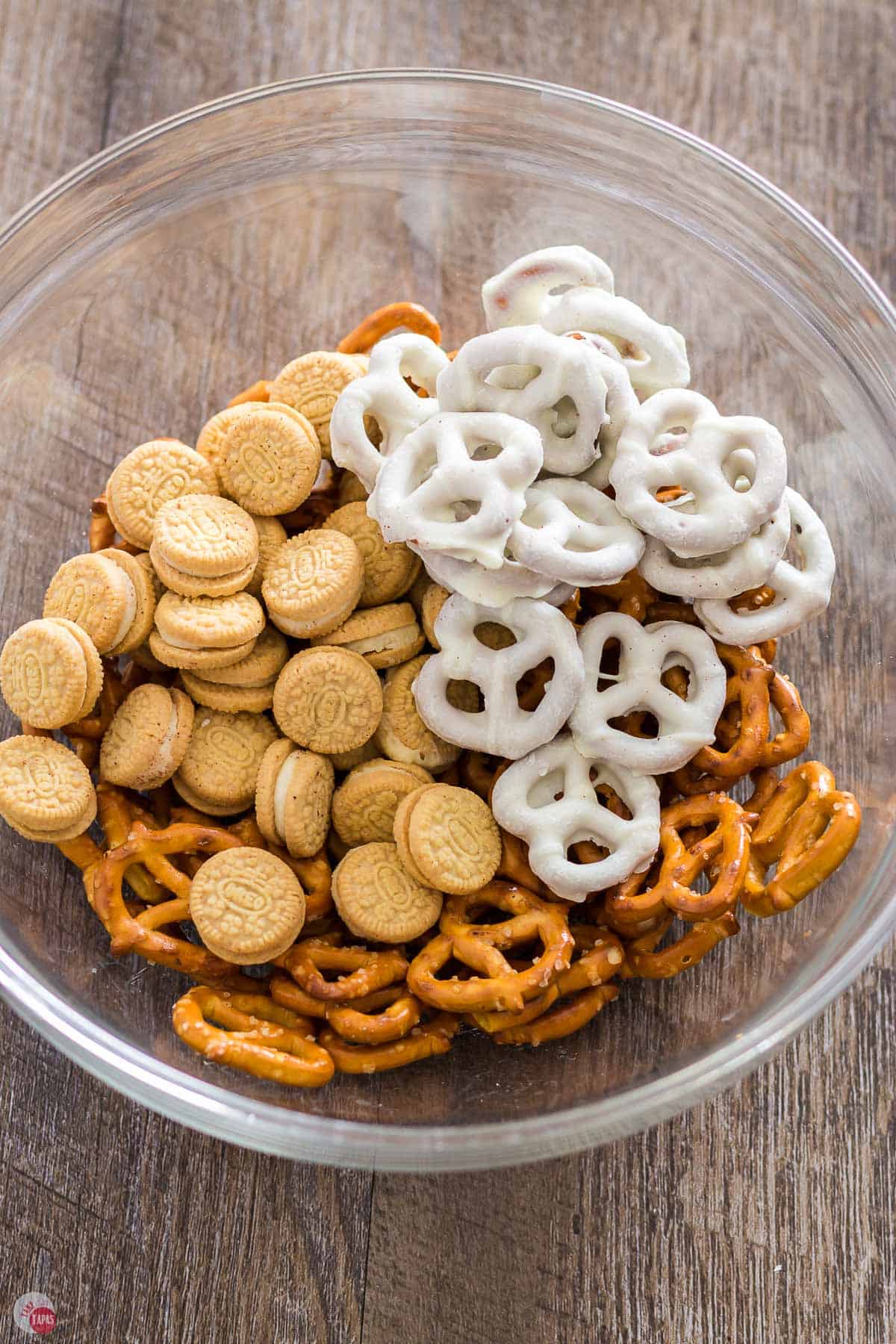 pretzels, mini oreo cookies, yogurt pretzels, in a clear bowl