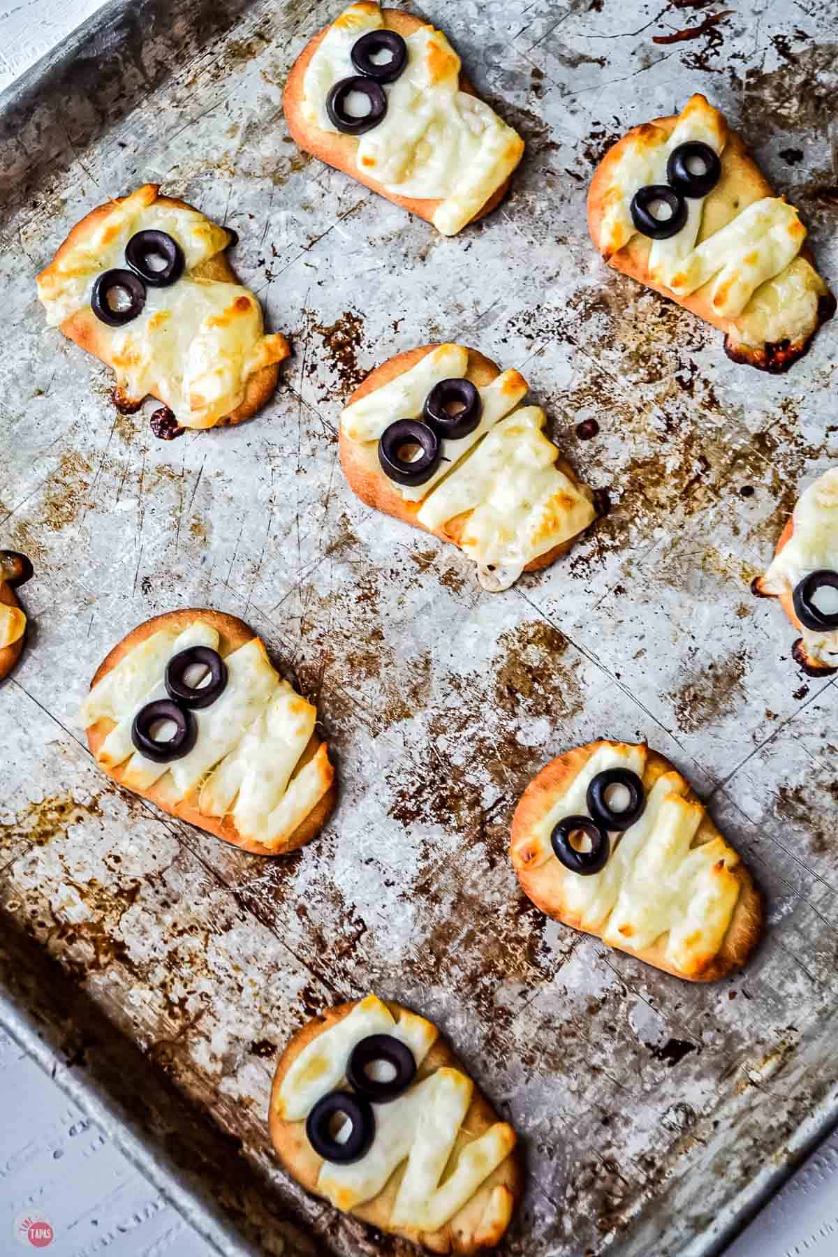 baked naan mummies on a baking sheet