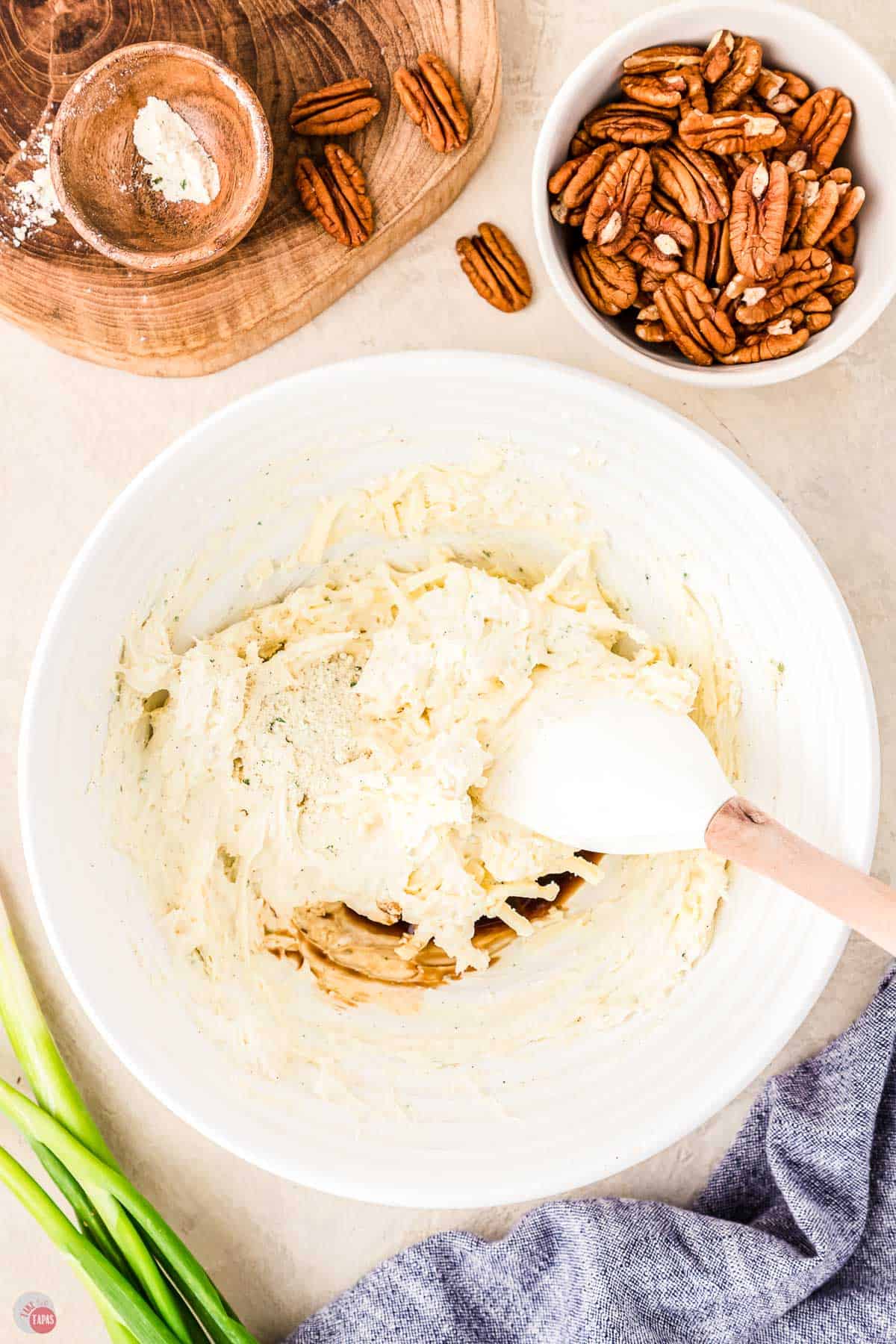 cream cheese and ranch mix being stirred together in a white bowl