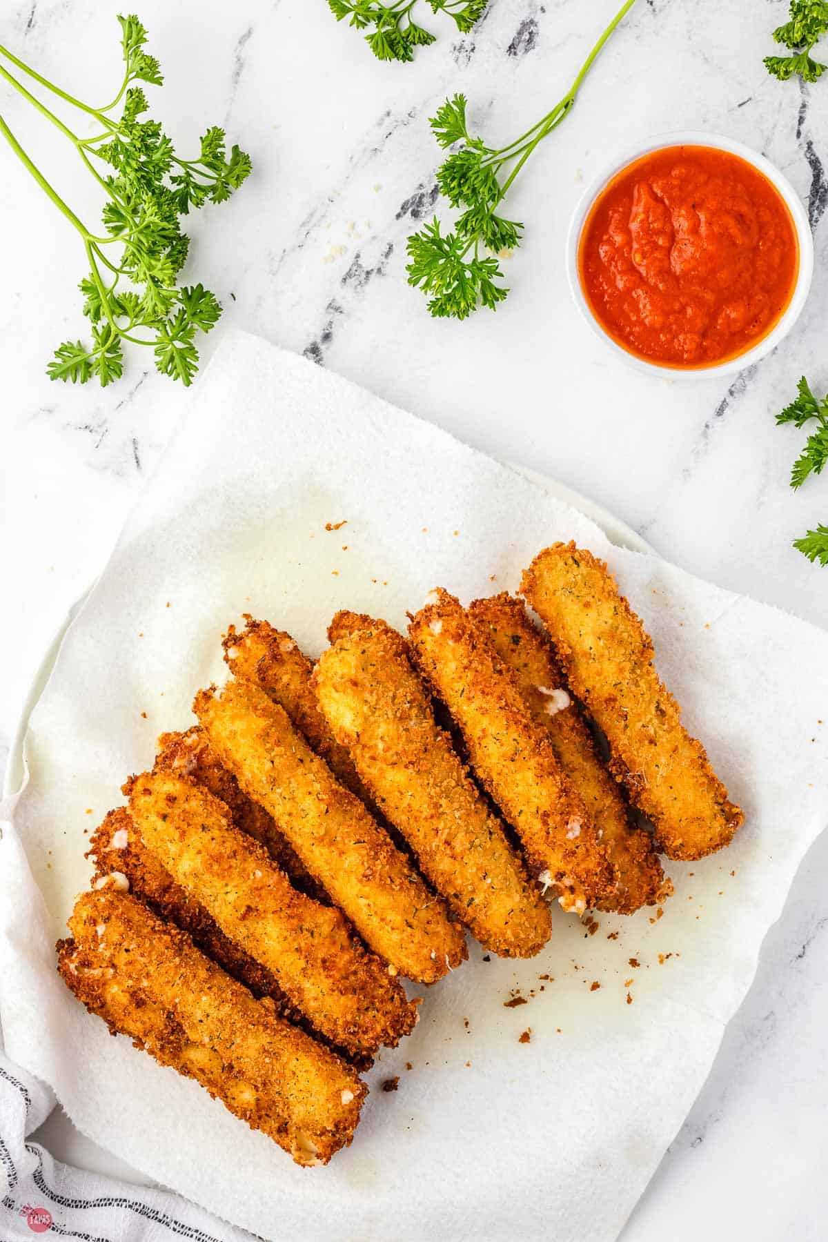 pile of fried cheese sticks on paper towels