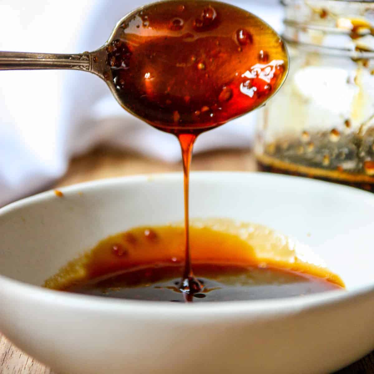 spoon dripping teriyaki sauce in a bowl