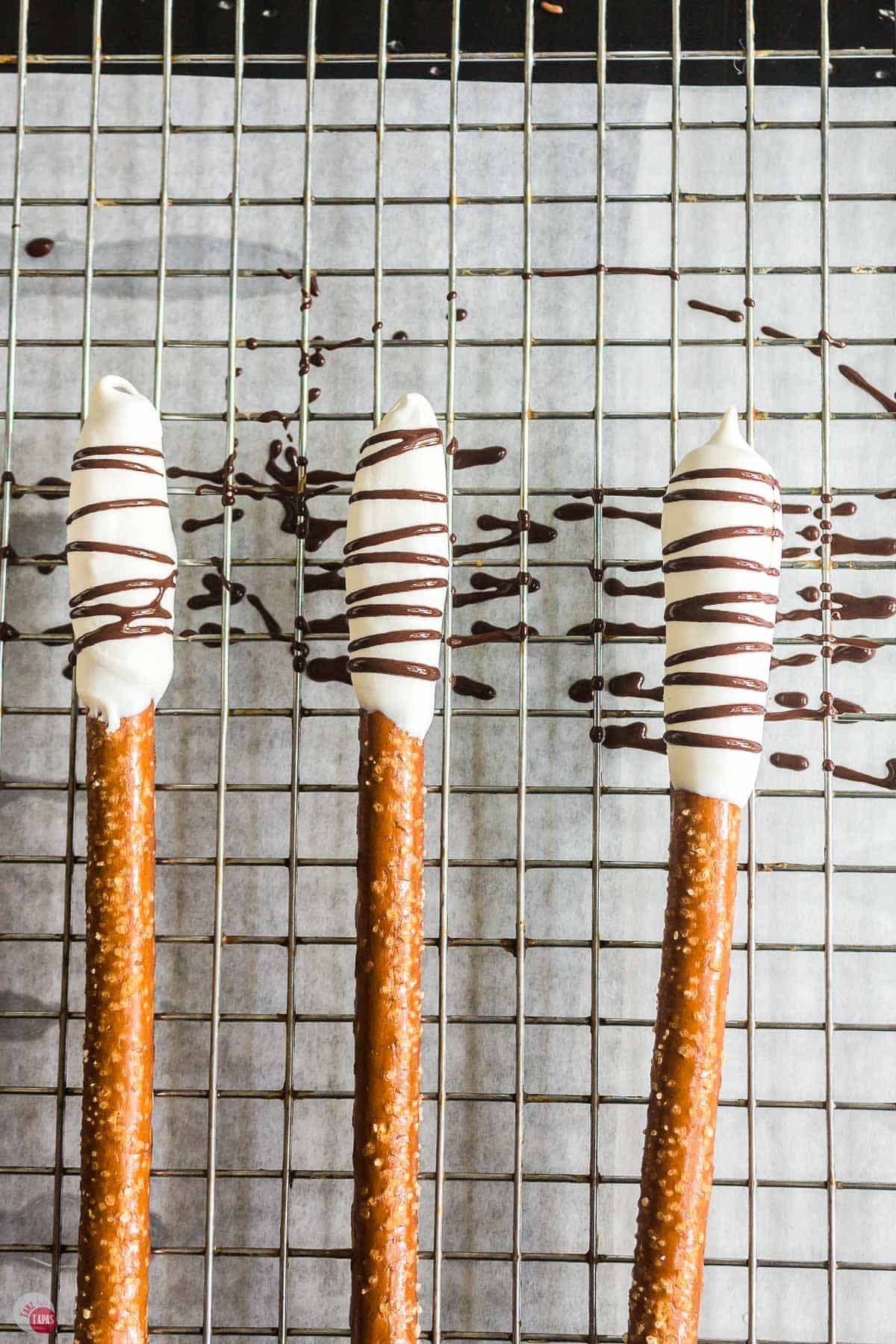 pretzels dipped in chocolate on a cooling rack