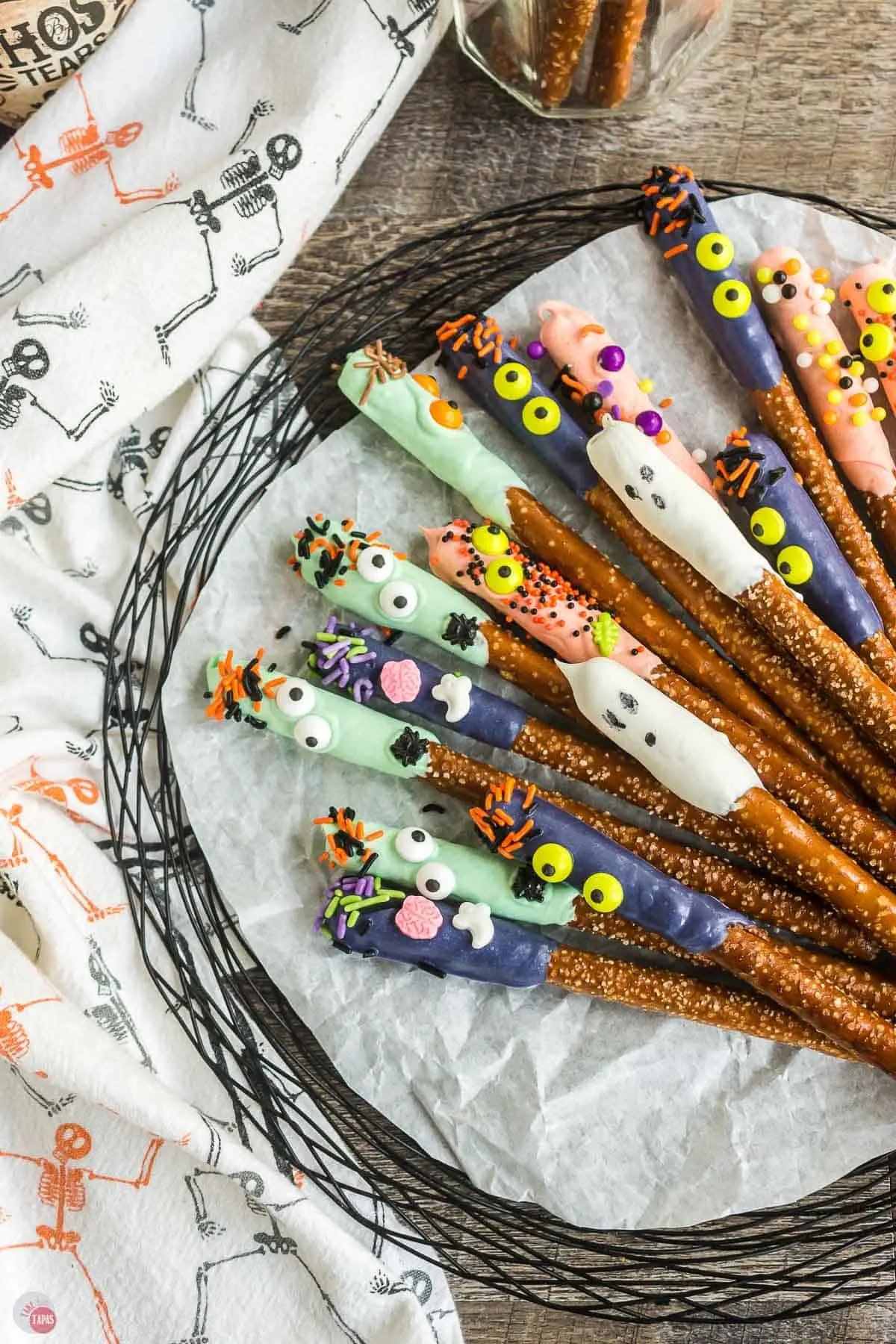 Halloween Pretzel Rods on a black platter