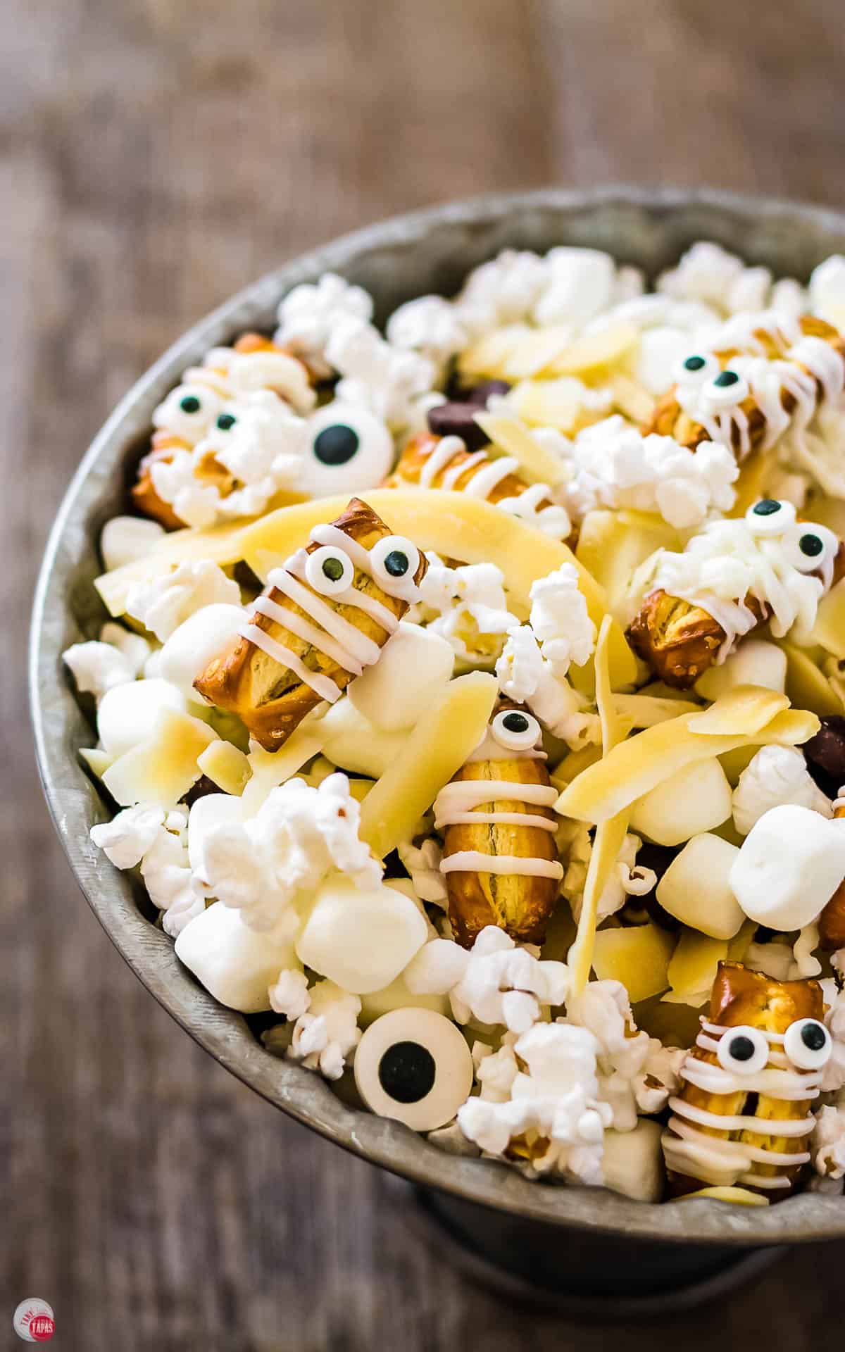 overhead picture of grey cake plate filled with halloween mummy mix