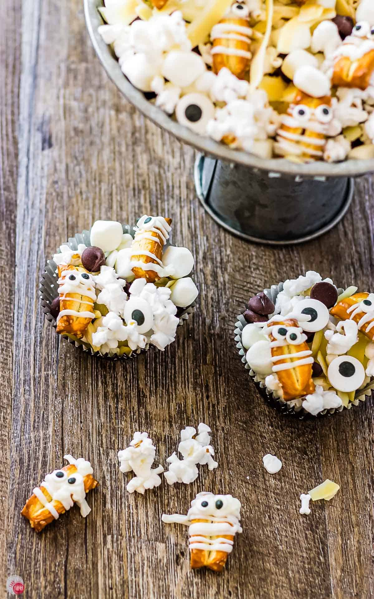 two cupcake liners filled with snack mix