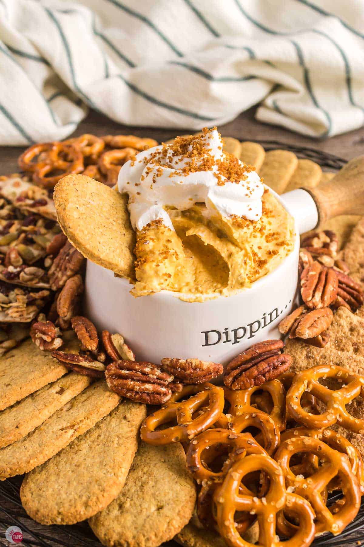 white bowl of dip in a tray of crackers